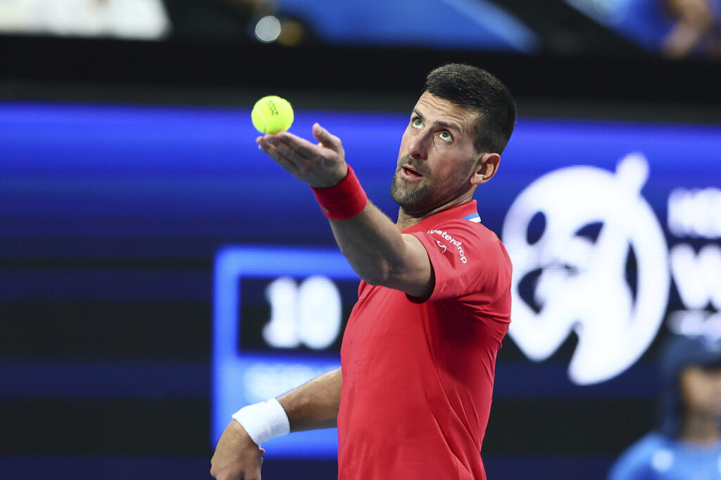 Novak Djokovic of Serbia serves to Zhizhen Zhang of China during the United Cup tennis tournament in Perth, Australia, Sunday, Dec. 31, 2023. (AP Photo/Trevor Collens)