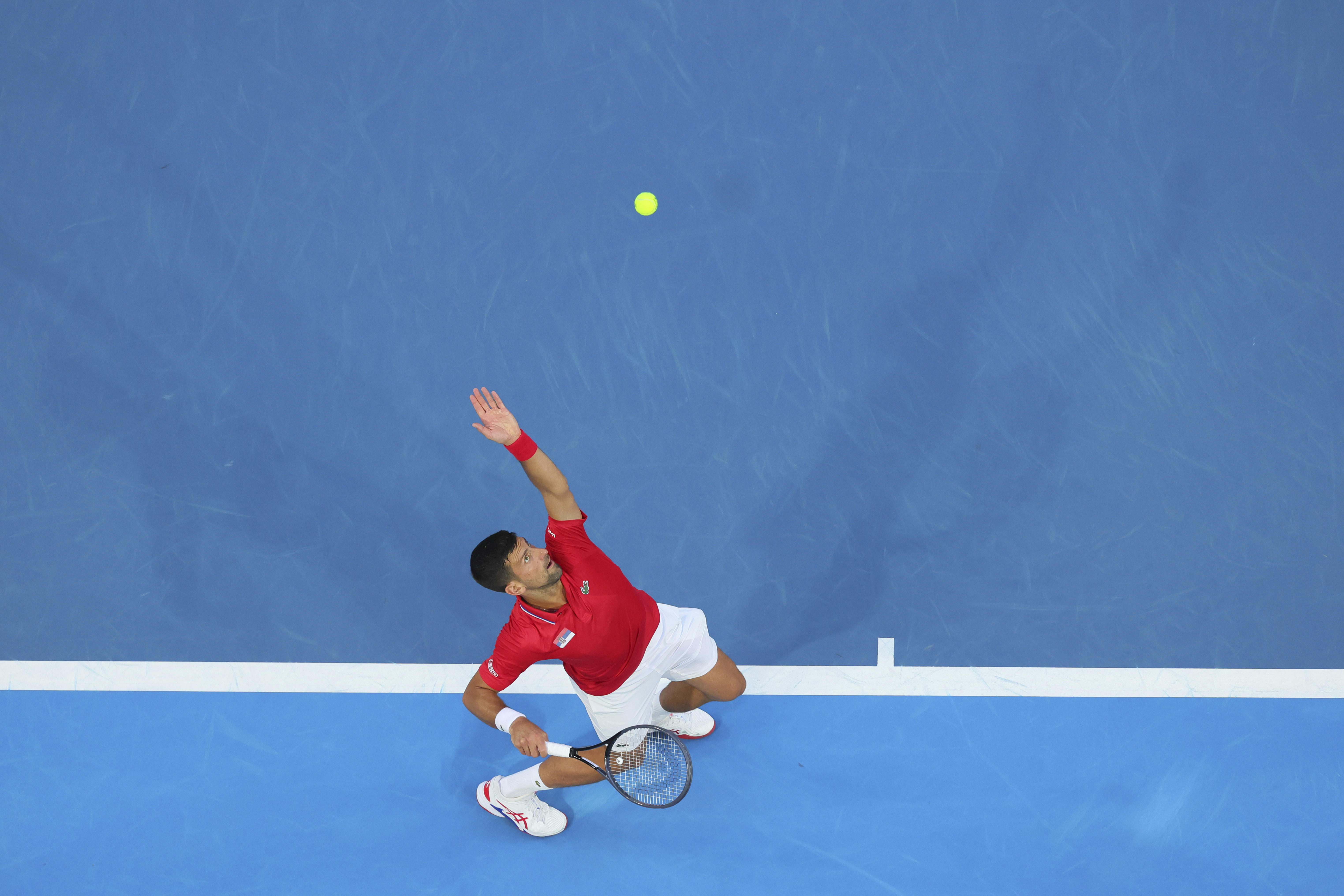 Novak Djokovic of Serbia serves to Zhizhen Zhang of China during the United Cup tennis tournament in Perth, Australia, Sunday, Dec. 31, 2023. (AP Photo/Trevor Collens)