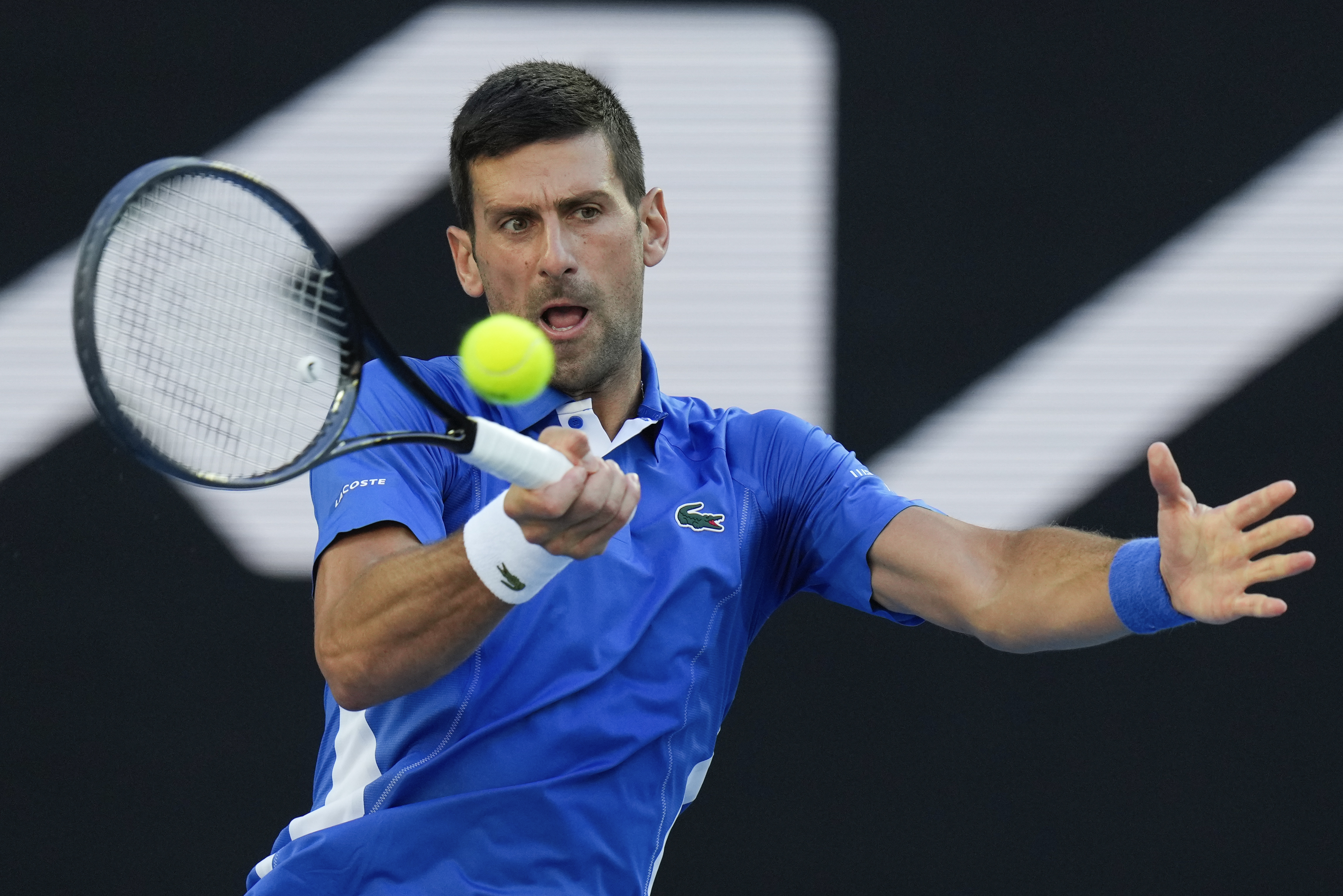 Serbia's Novak Djokovic plays a forehand return to during an exhibition match against Stefanos Tsitsipas of Greece ahead of the Australian Open tennis championships at Melbourne Park, Melbourne, Australia, Thursday, Jan. 11, 2024. (AP Photo/Andy Wong)