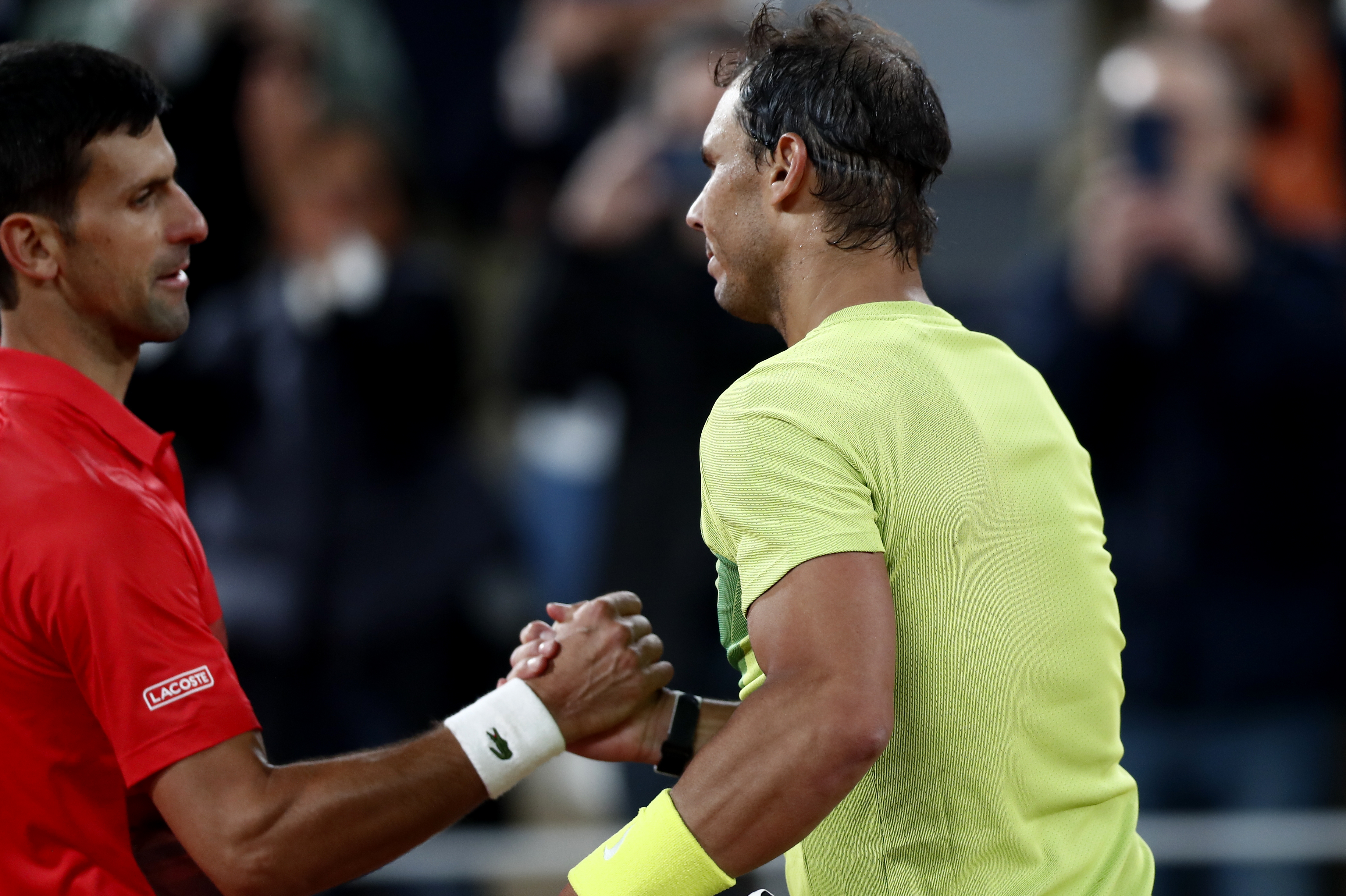 epa09988866 Rafael Nadal of Spain (R) reacts with Novak Djokovic of Serbia after winning their men?s quarterfinal match during the French Open tennis tournament at Roland ?Garros in Paris, France, 01 June 2022.  EPA-EFE/MOHAMMED BADRA