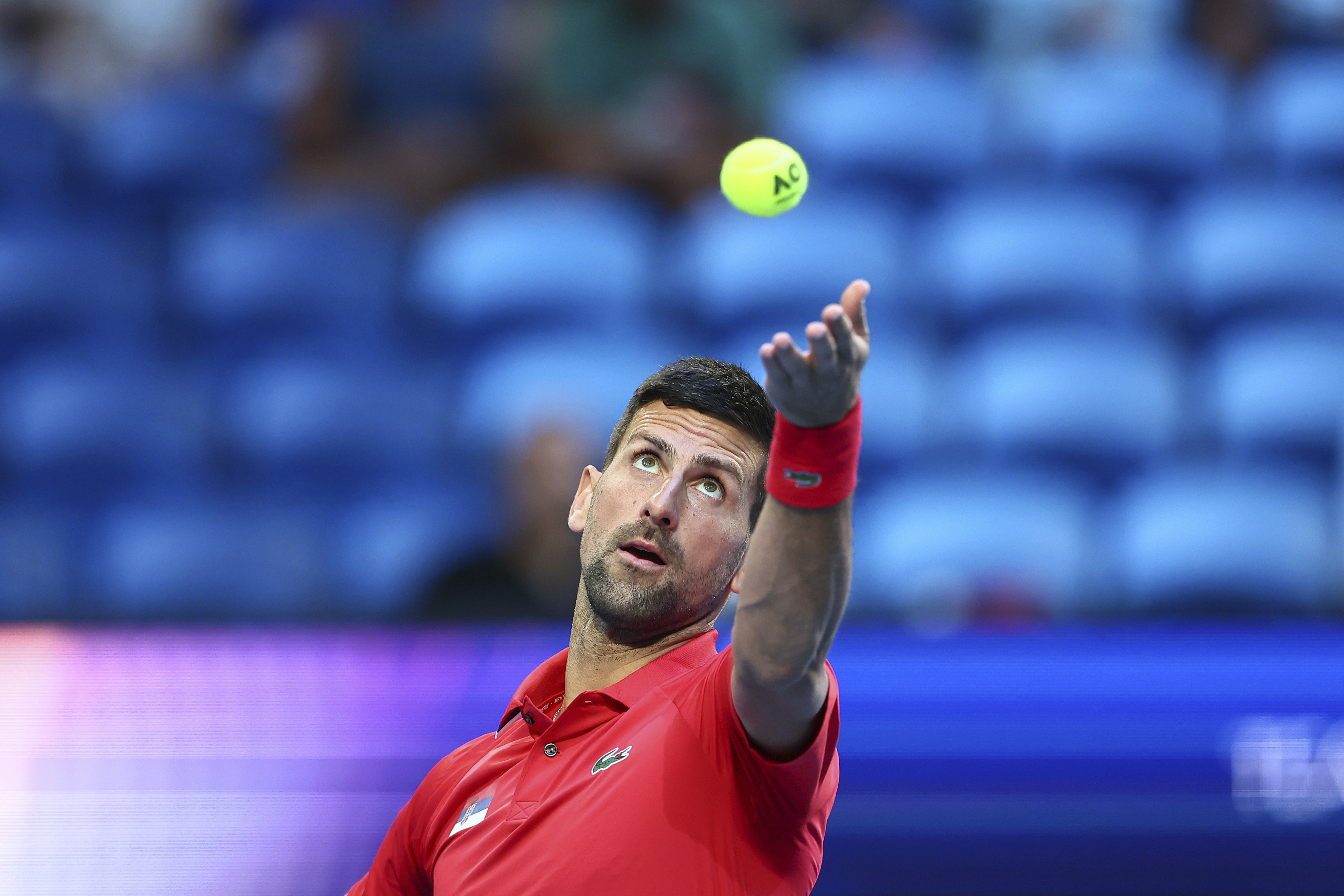 Novak Djokovic of Serbia serves to Zhizhen Zhang of China during the United Cup tennis tournament in Perth, Australia, Sunday, Dec. 31, 2023. (AP Photo/Trevor Collens)