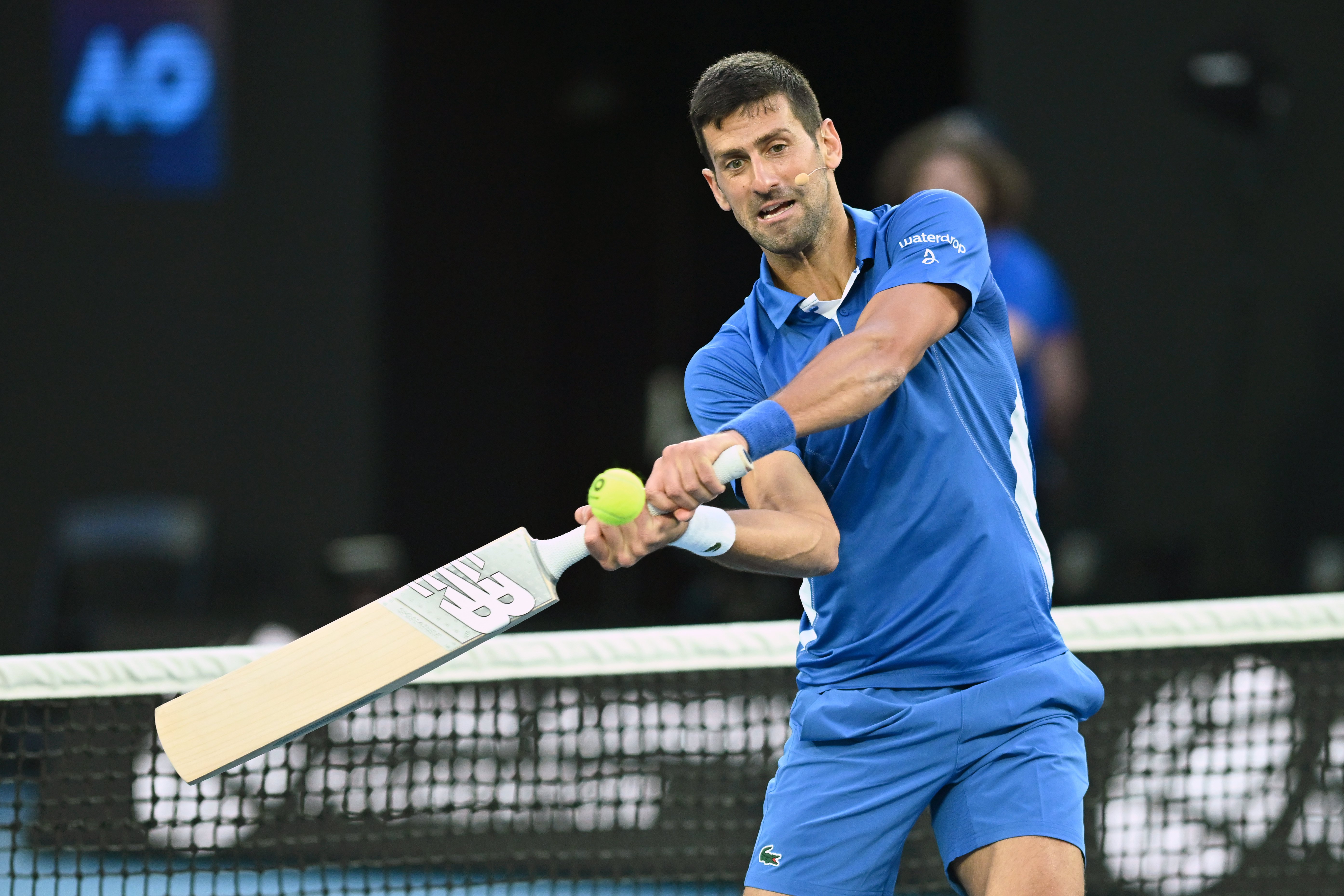 epaselect epa11068944 Novak Djokovic of Serbia uses a cricket bat during A Night with Novak and Friends charity tennis matches at Rod Laver Arena, Melbourne, Australia, 11 January 2024.  EPA-EFE/JOEL CARRETT AUSTRALIA AND NEW ZEALAND OUT