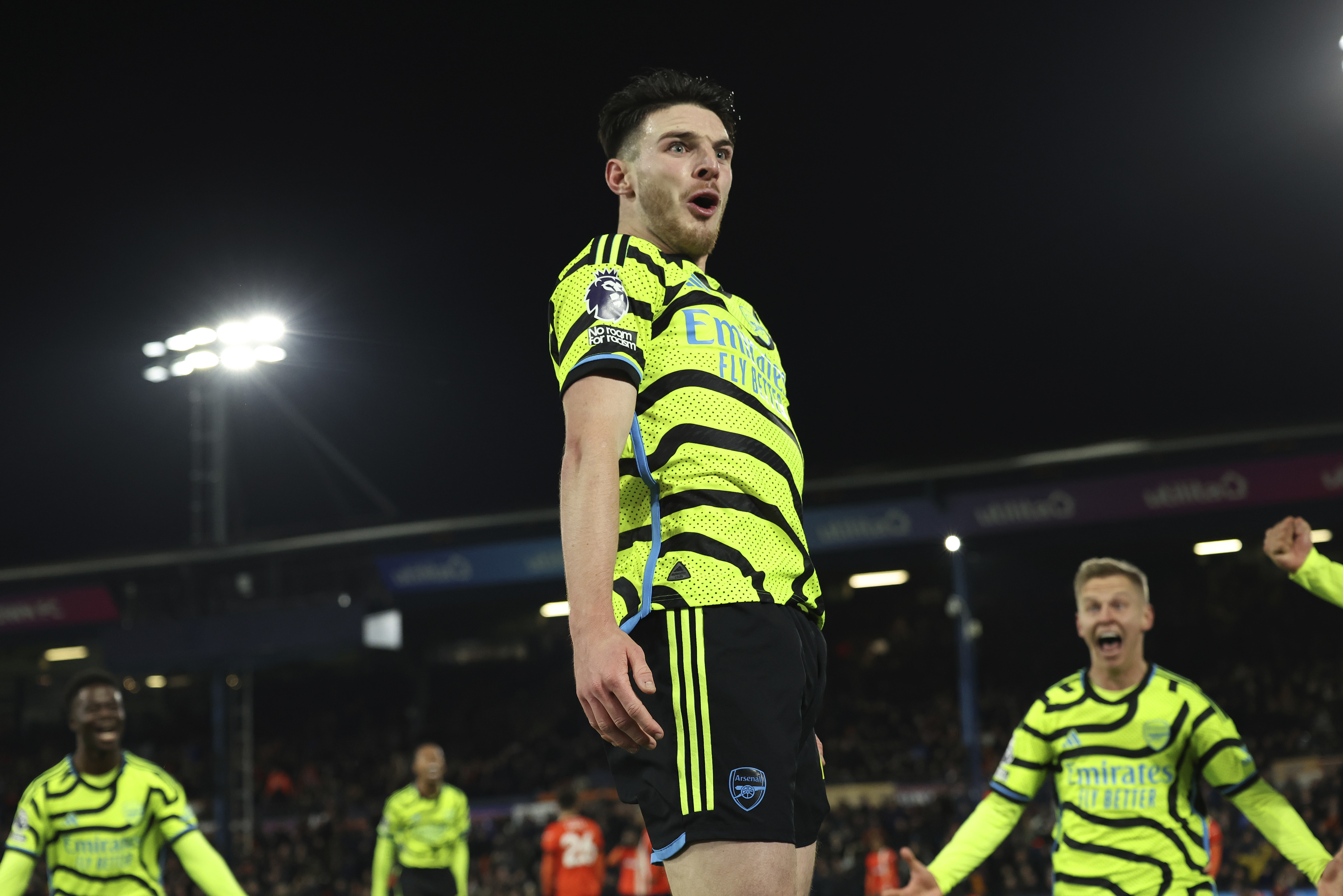 Arsenal's Declan Rice celebrates after scoring his side's fourth goal during the English Premier League soccer match between Luton and Arsenal at Kenilworth Road, Luton, England, Tuesday, Dec. 5, 2023. (AP Photo/Ian Walton)