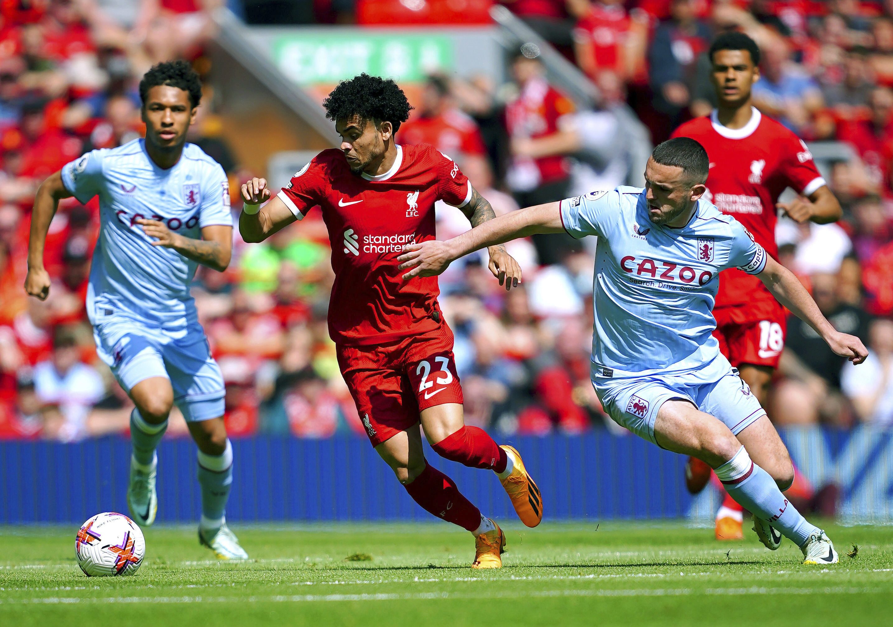 Liverpool's Luis Diaz, centre, and Aston Villa's John McGinn vie  for the ball, during the English Premier League soccer match between Liverpool and Aston Villa,  at Anfield stadium, Liverpool, England, Saturday May 20, 2023. (Peter Byrne/PA via AP)