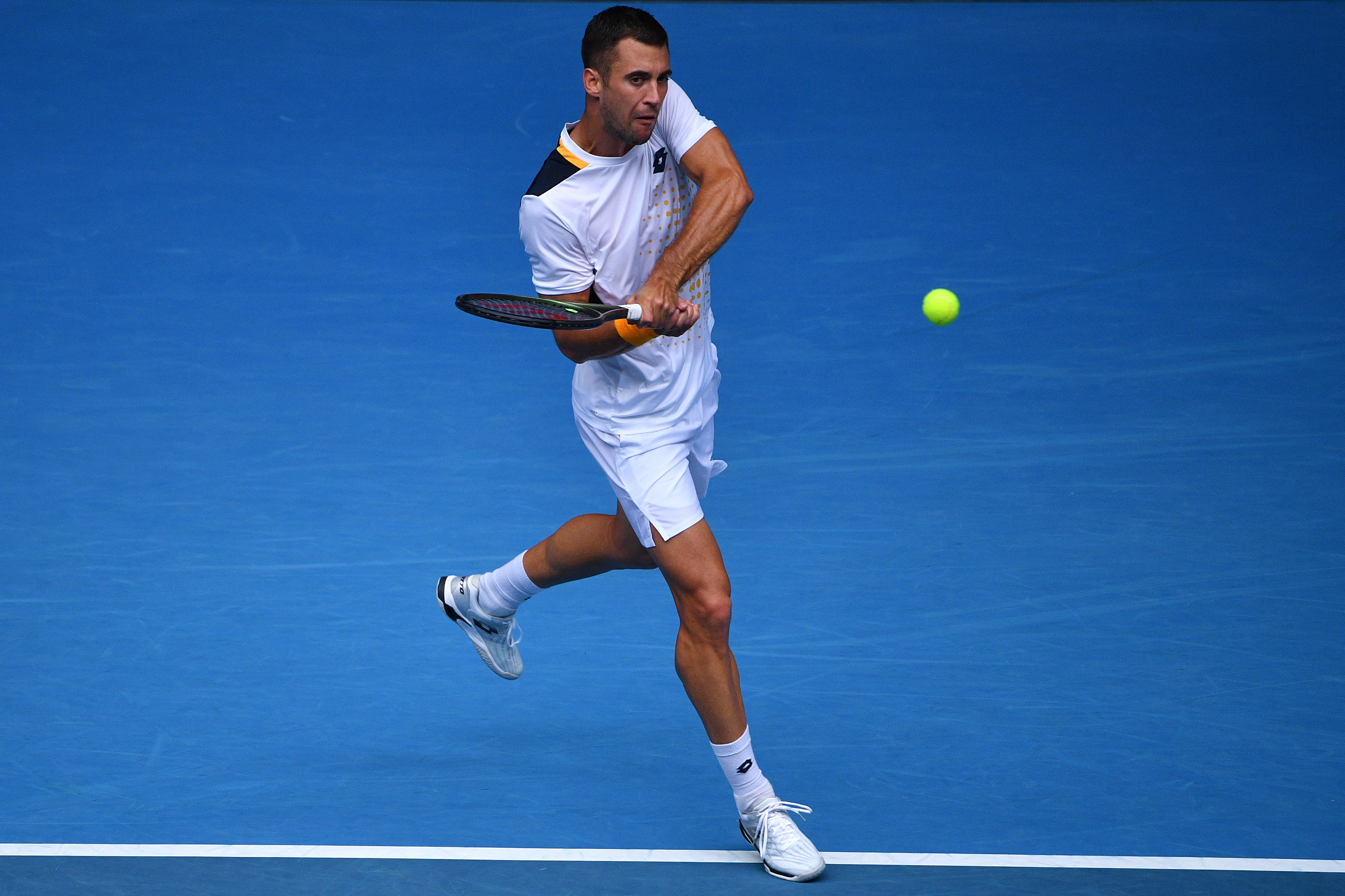 epa09690146 Laslo Djere of Serbia returns during the Men's singles match against Denis Shapovalov of Canada on Day 1 of the Australian Open, at Melbourne Park, in Melbourne, Australia, 17 January 2022.  EPA-EFE/JAMES ROSS AUSTRALIA AND NEW ZEALAND OUT