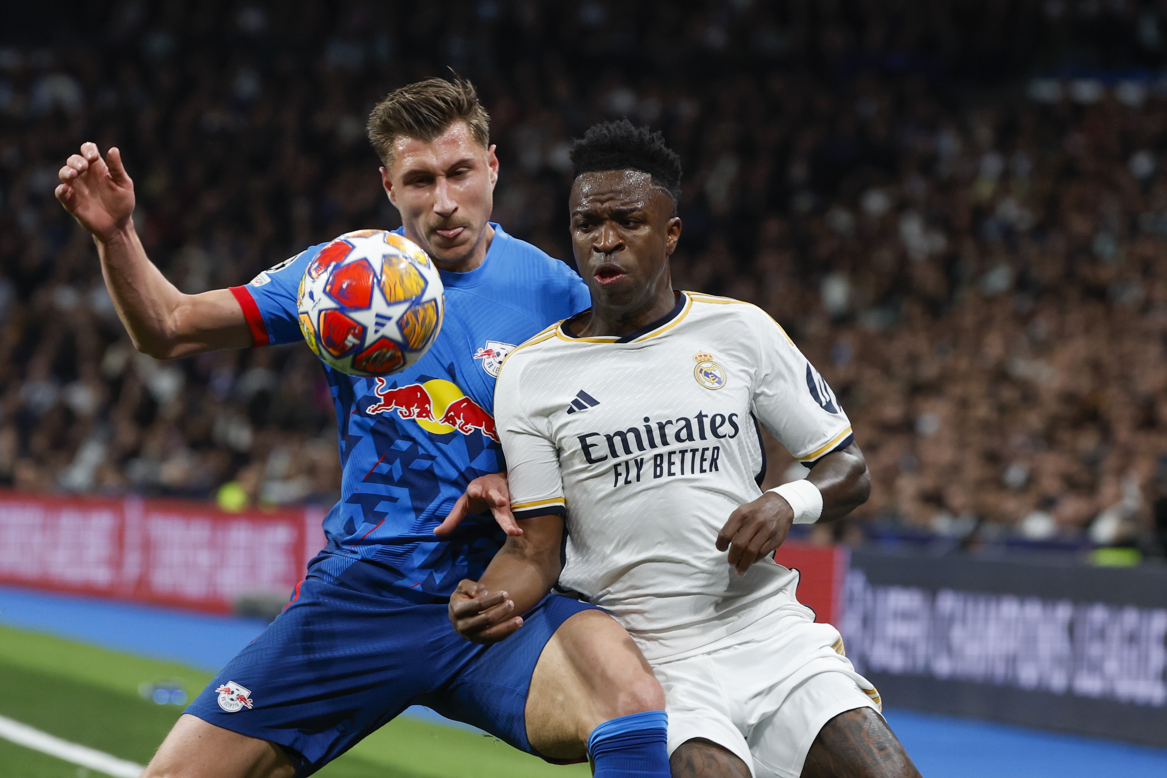 epa11202758 Real Madrid's Vinicius Jr (R) in action against Leipzig's Willi Orban (L) during the UEFA Champions League round of 16 second leg soccer match between Real Madrid and RB Leipzig in Madrid, Spain, 06 March 2024.  EPA-EFE/J.J. Guillen
