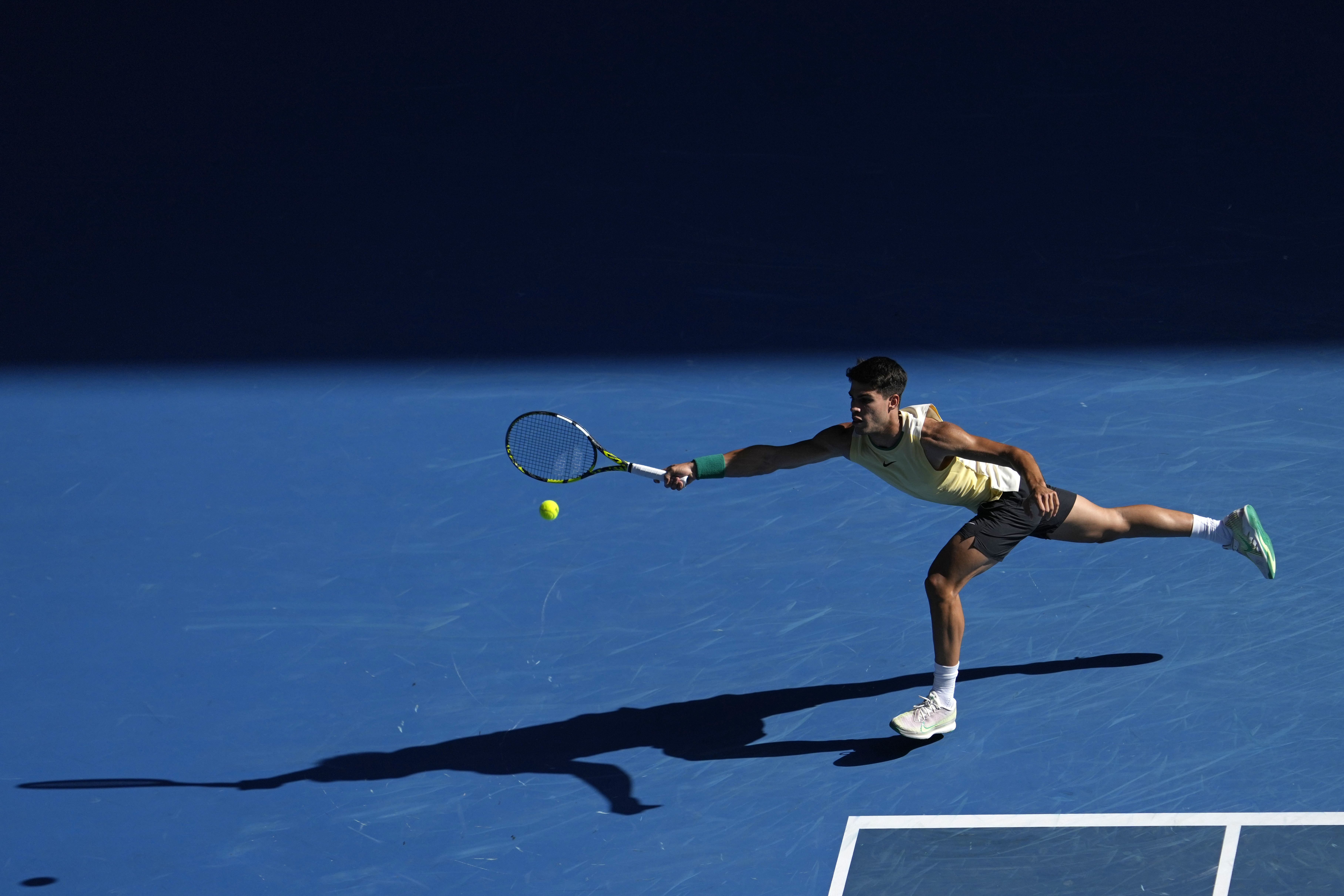 Carlos Alcaraz of Spain plays a forehand return to Lorenzo Sonego of Italy during their second round match at the Australian Open tennis championships at Melbourne Park, Melbourne, Australia, Thursday, Jan. 18, 2024. (AP Photo/Andy Wong)