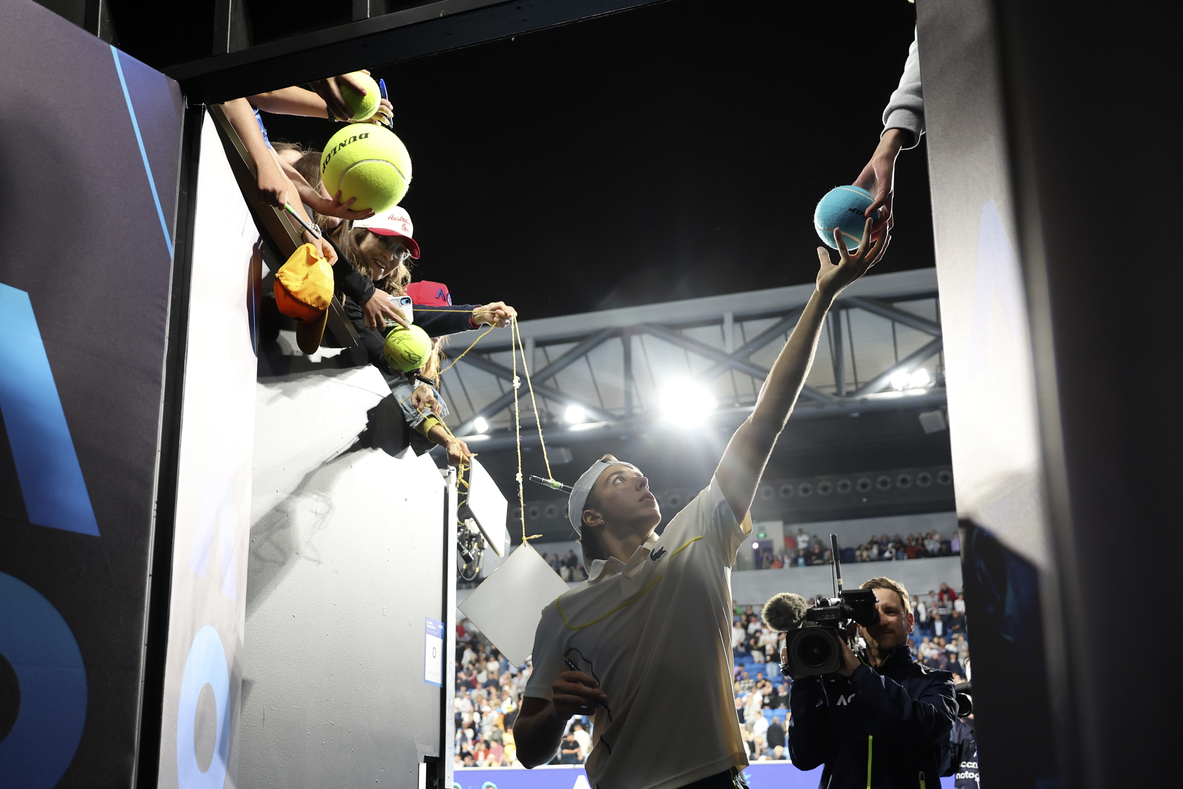 Arthur Cazaux of France signs autographs after defeating Holger Rune of Denmark in their second round match at the Australian Open tennis championships at Melbourne Park, Melbourne, Australia, Thursday, Jan. 18, 2024. (AP Photo/Asanka Brendon Ratnayake)