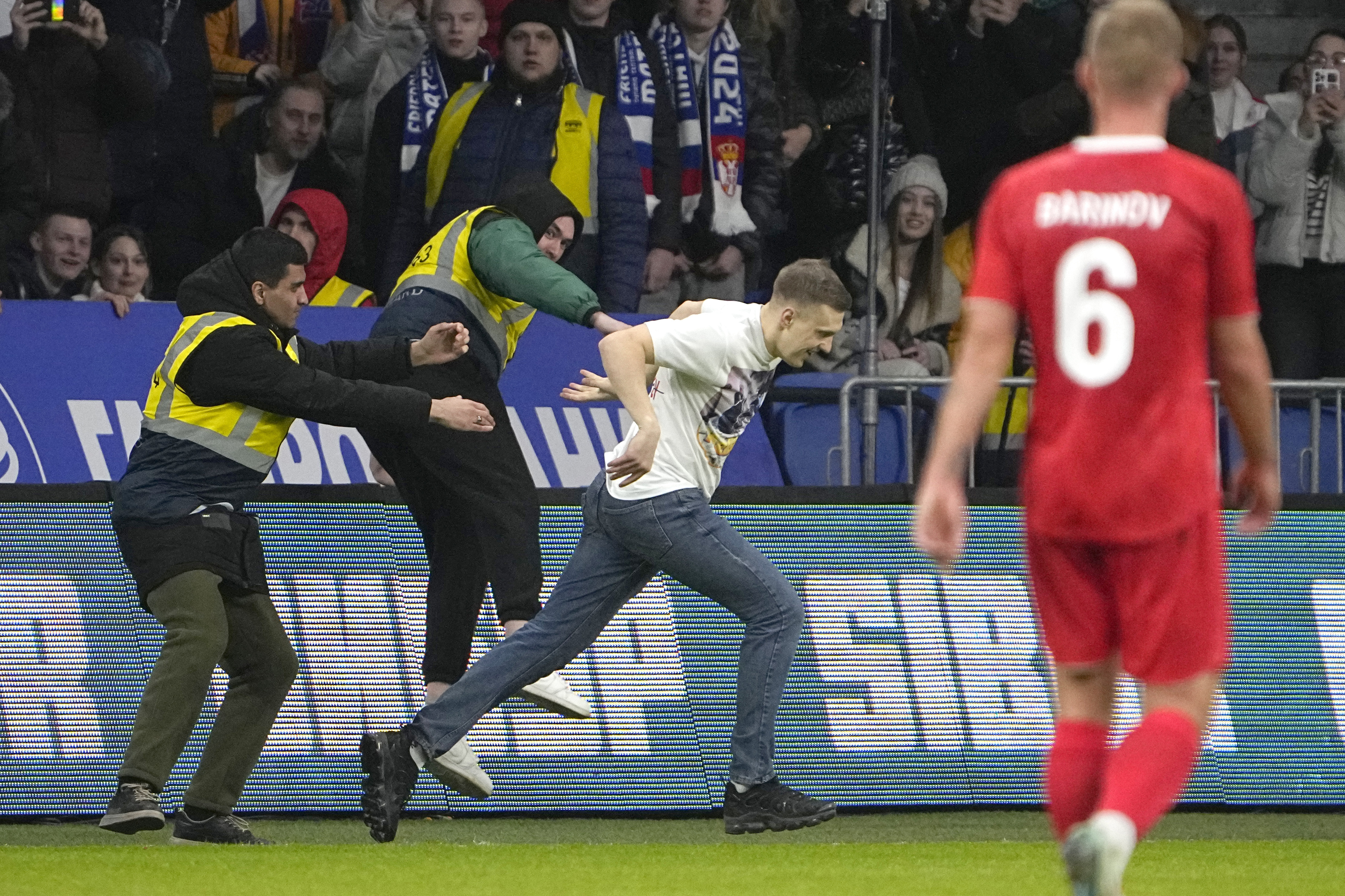 A soccer fan invades the pitch during an international friendly soccer match between Russia and Serbia at the Central Dynamo Stadium of Lev Yashin in Moscow, Russia, Thursday, March 21, 2024. (AP Photo/Alexander Zemlianichenko)