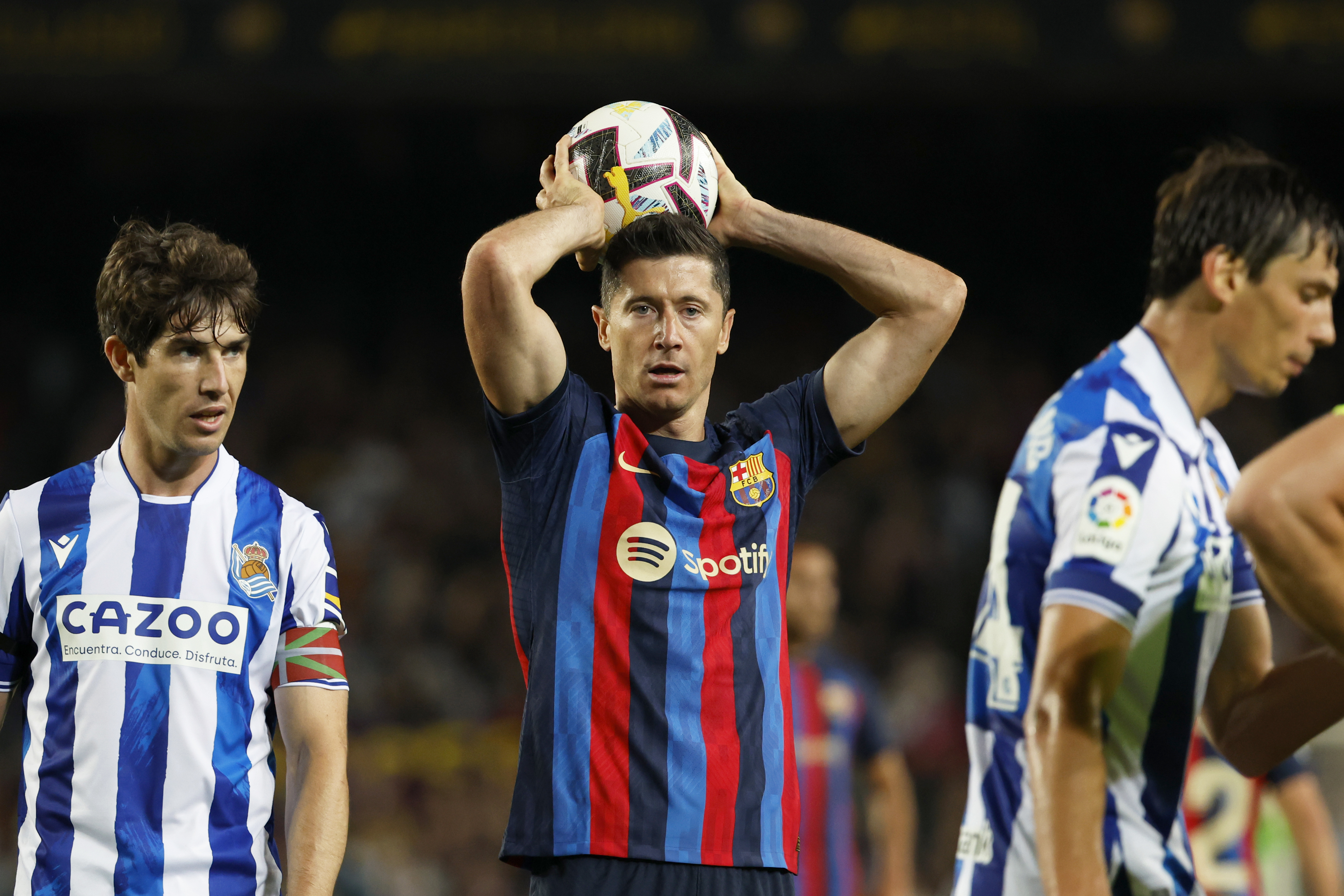 Barcelona's Robert Lewandowski holds the ball during a Spanish La Liga soccer match between Barcelona and Real Sociedad at Camp Nou stadium in Barcelona, Spain, Saturday, May 20, 2023. (AP Photo/Joan Monfort)