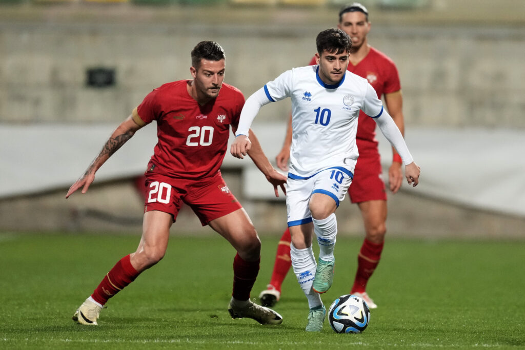 Serbias' Sergej Milinkovic-Savic, left, and Cyprus' Loizos Loizou challenge for the ball during an international friendly soccer match between Cyprus and Serbia at AEK arena stadium in Larnaca, Cyprus, Monday, March 25, 2024. (AP Photo/Petros Karadjias)