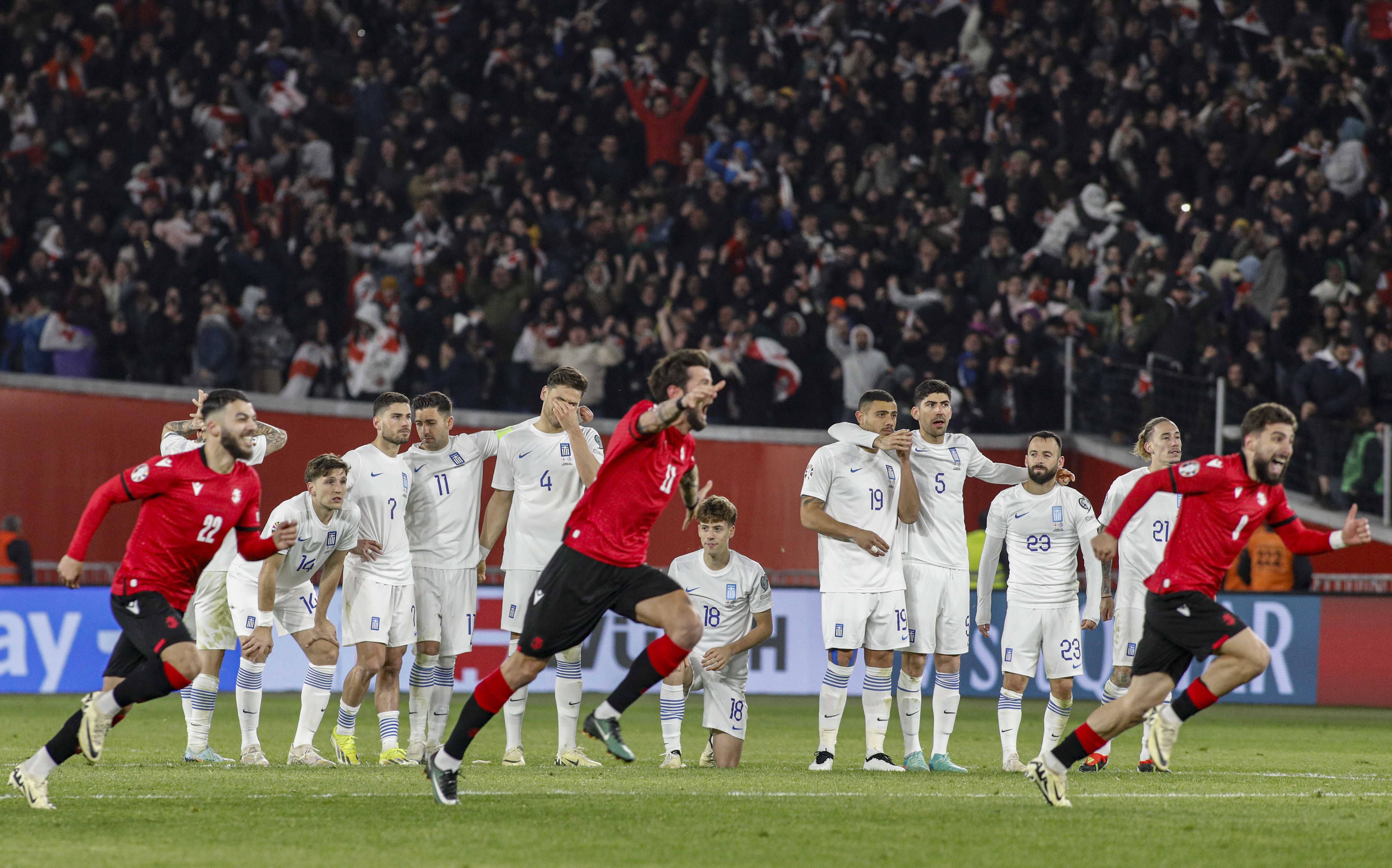 epa11245288 Georgia players celebrate as Greece players react during the UEFA EURO 2024 play-off between Georgia and Greece in Tbilisi, Georgia, 26 March 2024.  EPA-EFE/DAVID MDZINARISHVILI