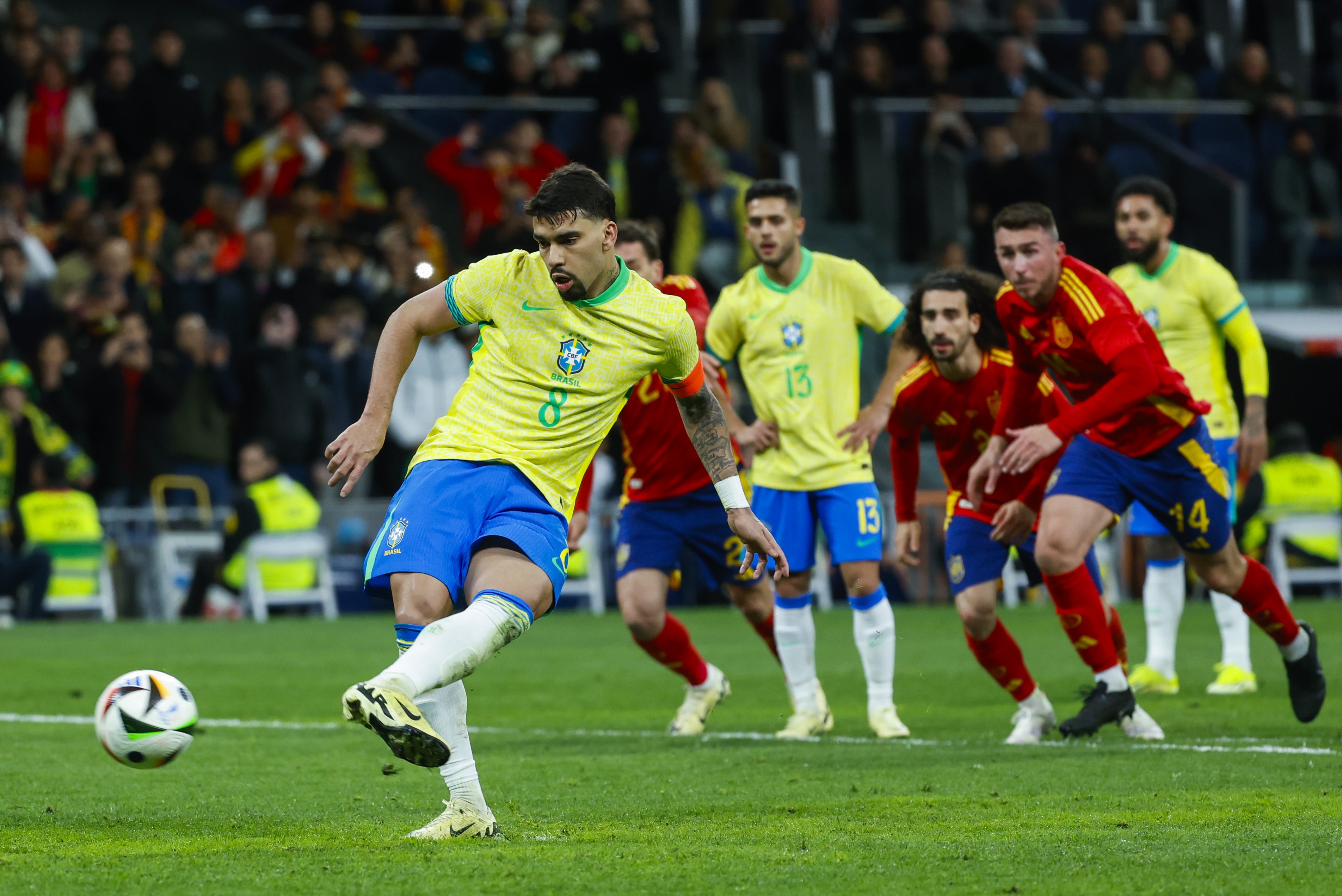 epa11245983 Brazil's Lucas Paqueta (L) scores the 3-3 equalizer from the penalty spot during the international friendly soccer match between Spain and Brazil, in Madrid, Spain, 26 March 2024.  EPA-EFE/Mariscal