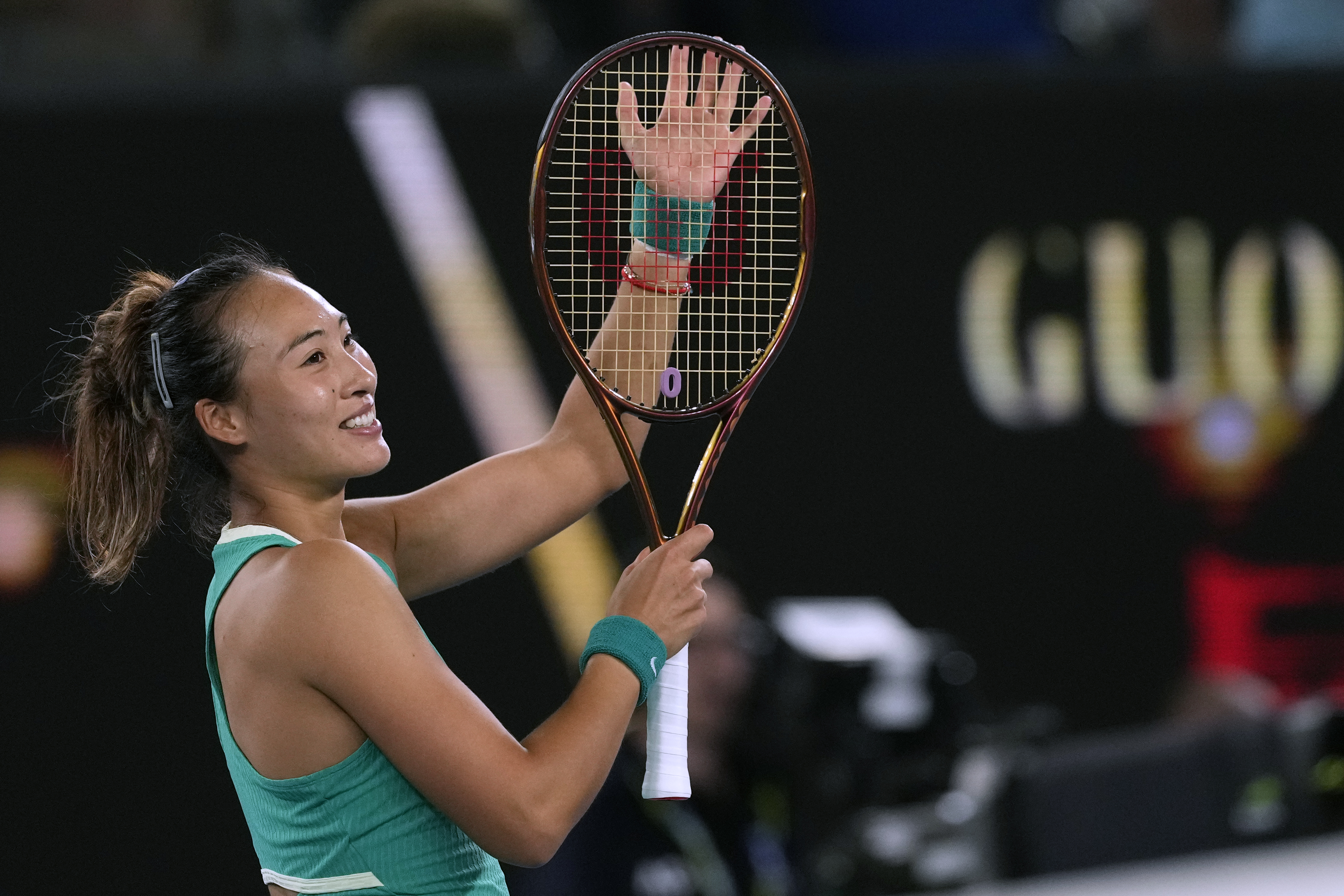 Zheng Qinwen of China waves after defeating Anna Kalinskaya of Russia in their quarterfinal match at the Australian Open tennis championships at Melbourne Park, Melbourne, Australia, Wednesday, Jan. 24, 2024. (AP Photo/Alessandra Tarantino)