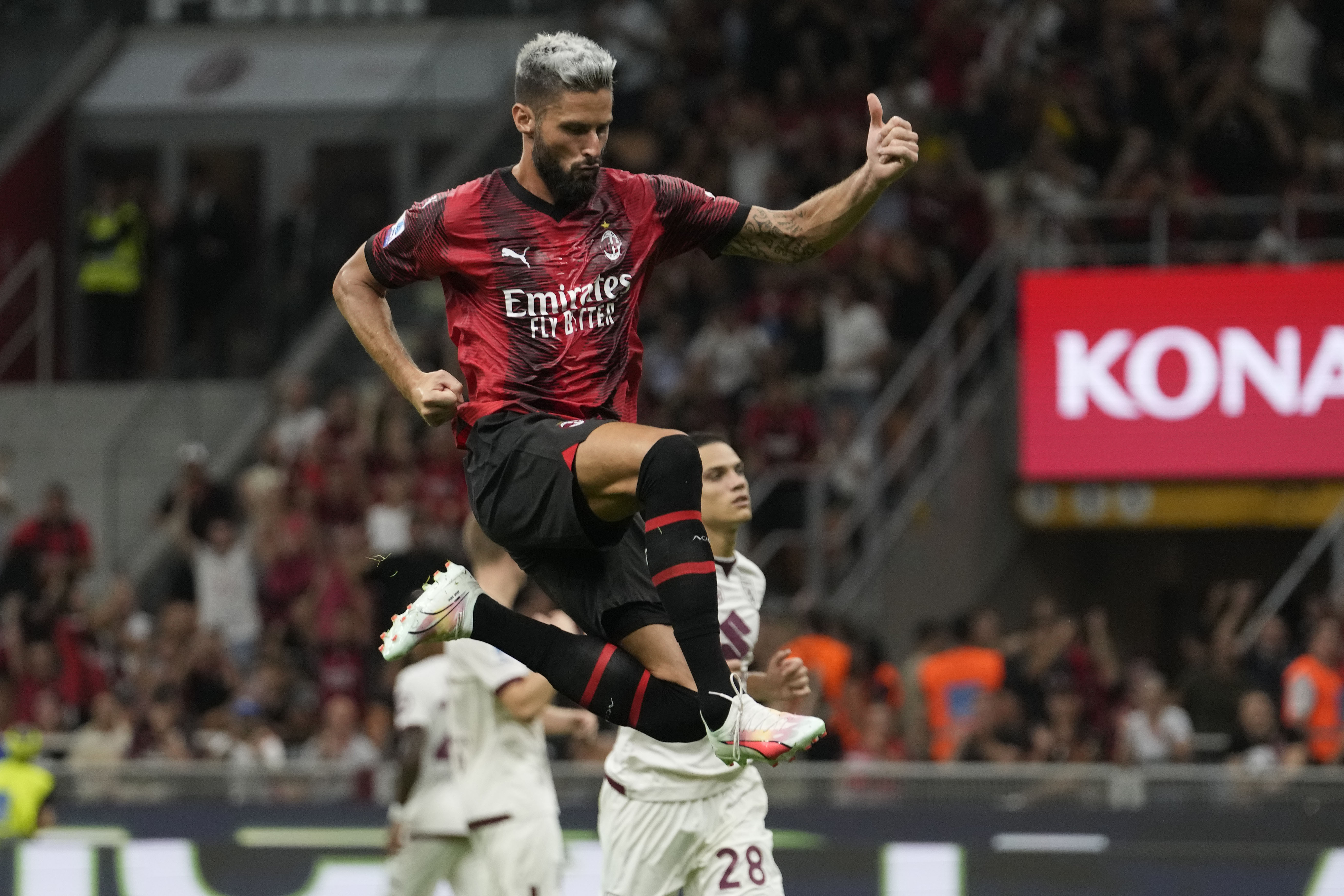AC Milan's Olivier Giroud celebrates after scoring on penalty his side's fourth goal during a Serie A soccer match between AC Milan and ,Torino at the San Siro stadium in Milan, Italy, Saturday, Aug. 26, 2023. (AP Photo/Luca Bruno)