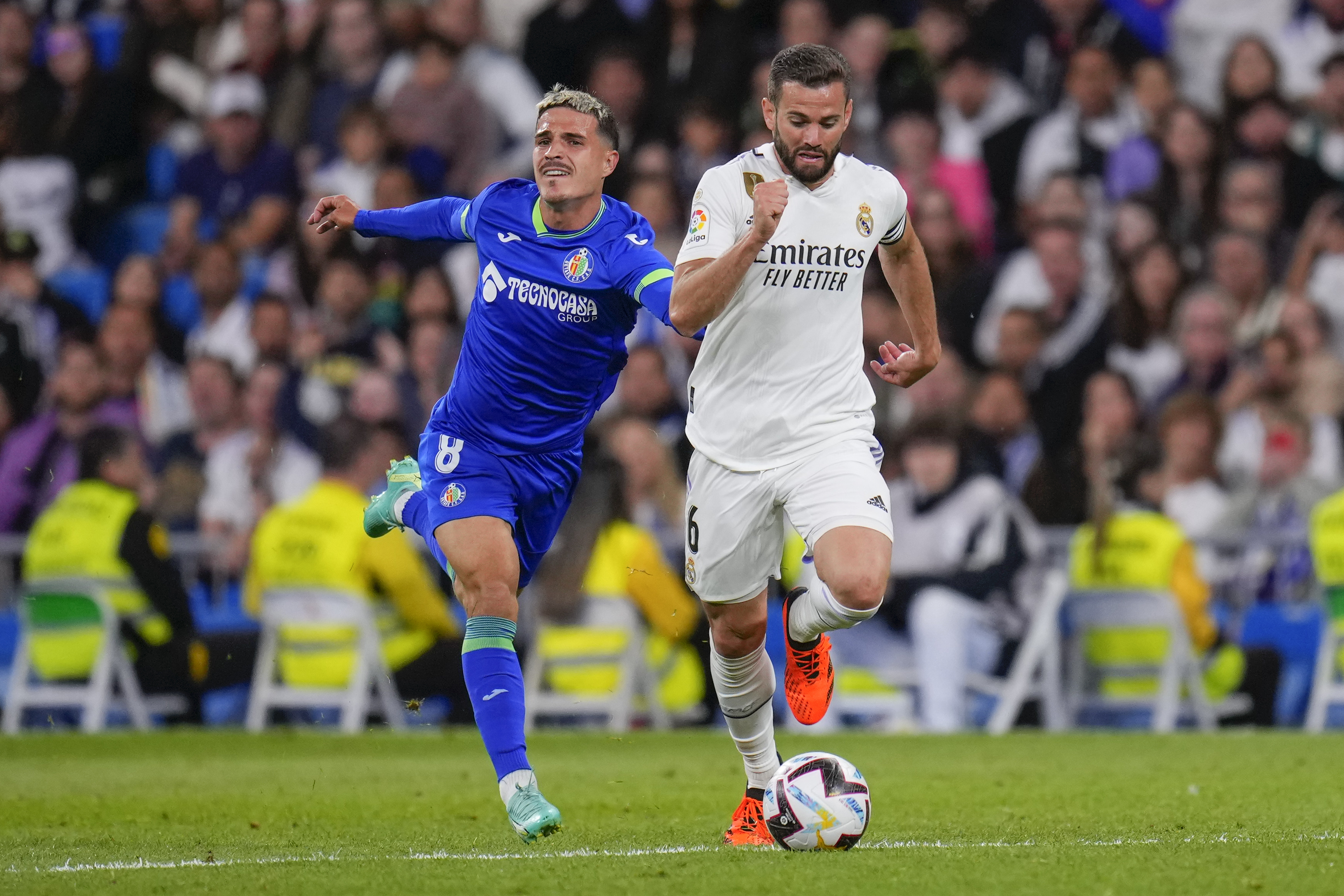 Real Madrid's Nacho, right, is challenged by Getafe's Jaime Seoane during a Spanish La Liga soccer match between Real Madrid and Getafe at the Santiago Bernabeu stadium in Madrid, Spain, Saturday, May 13, 2023. (AP Photo/Manu Fernandez)