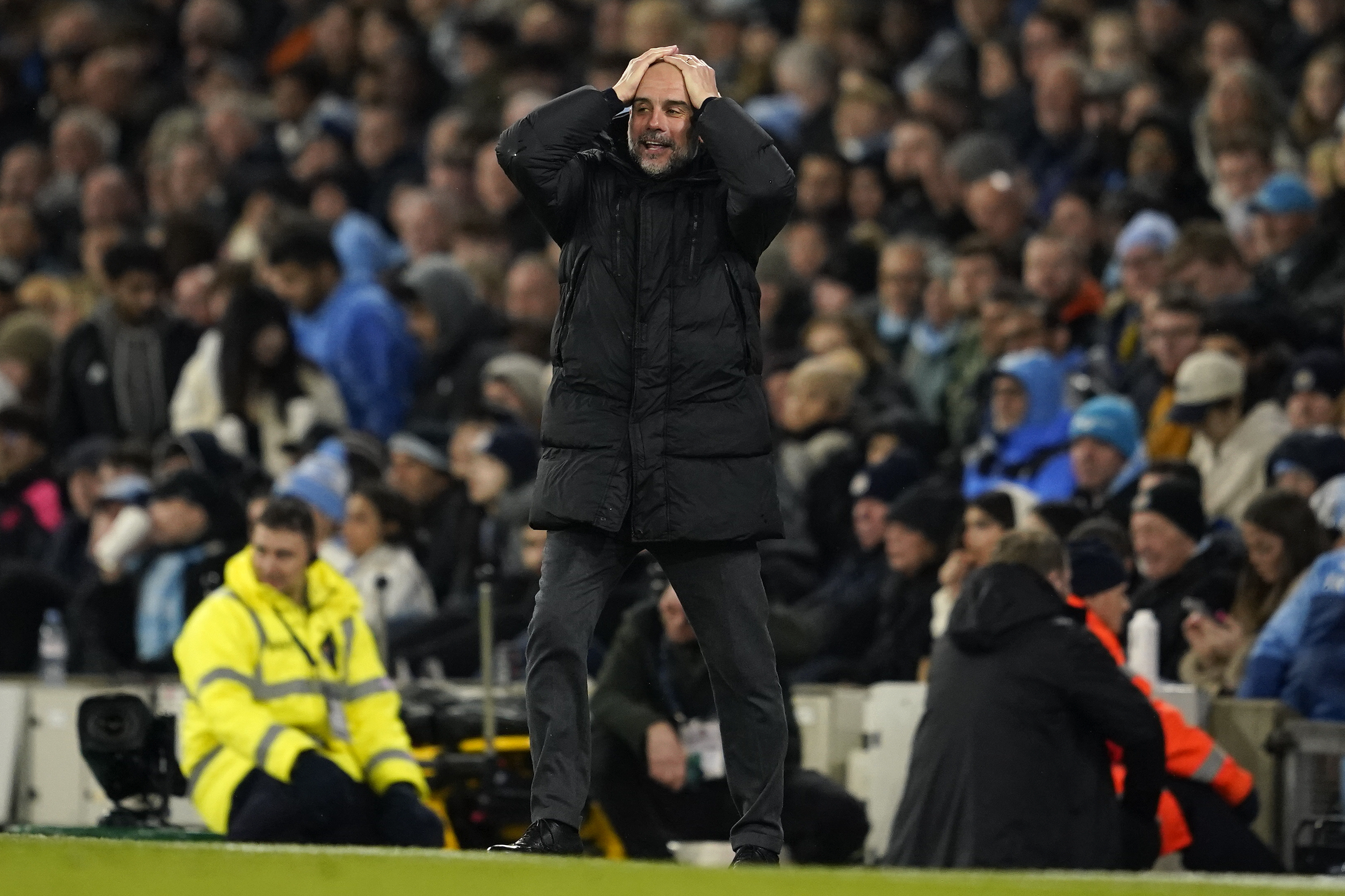 Manchester City's head coach Pep Guardiola reacts during the English Premier League soccer match between Manchester City and Chelsea at the Etihad stadium in Manchester, England, Saturday, Feb. 17, 2024. (AP Photo/Dave Thompson)