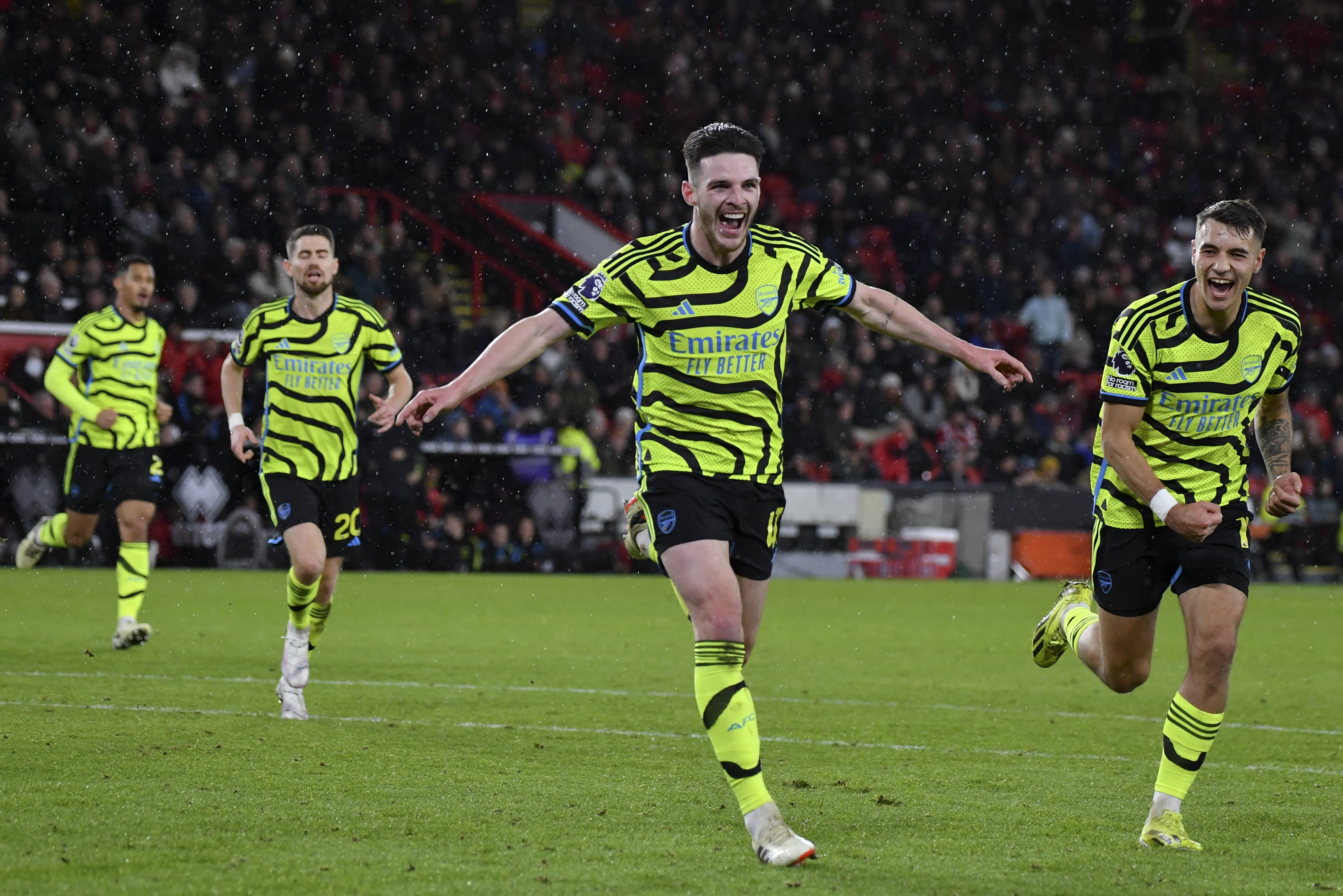 Arsenal's Declan Rice celebrates after scoring his side's fifth goal during the English Premier League soccer match between Sheffield United and Arsenal at the Bramall Lane stadium in Sheffield, England, Monday, March 4, 2024. (AP Photo/Rui Vieira)