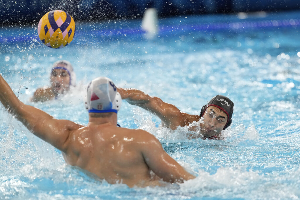 Japan's Keigo Okawa scores a goal during the men's Water Polo Group B preliminary match between Serbia and Japan at the 2024 Summer Olympics, Sunday, July 28, 2024, in Saint-Denis, France. (AP Photo/Luca Bruno)