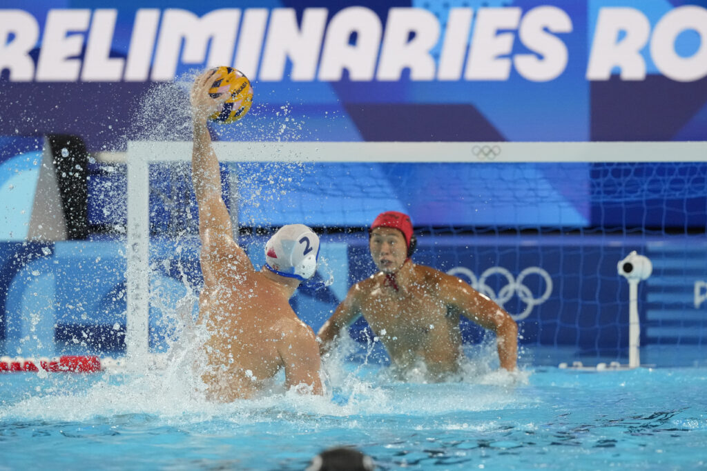 Serbia's Dusan Mandic scores a goal against Japan's goalkeeper Towa Nishimura during the men's Water Polo Group B preliminary match between Serbia and Japan at the 2024 Summer Olympics, Sunday, July 28, 2024, in Saint-Denis, France. (AP Photo/Luca Bruno)
