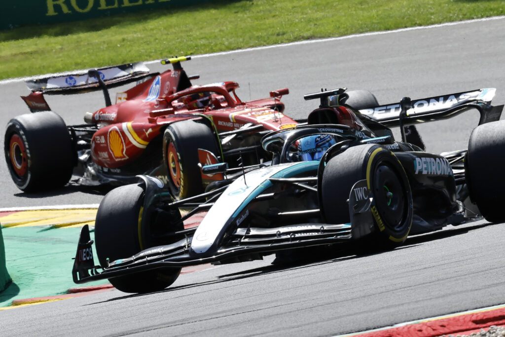 Mercedes driver George Russell of Britain, right, steers his car ahead of Ferrari driver Carlos Sainz of Spain during the Formula One Grand Prix at the Spa-Francorchamps racetrack in Spa, Belgium, Sunday, July 28, 2024. (AP Photo/Geert Vanden Wijngaert)
