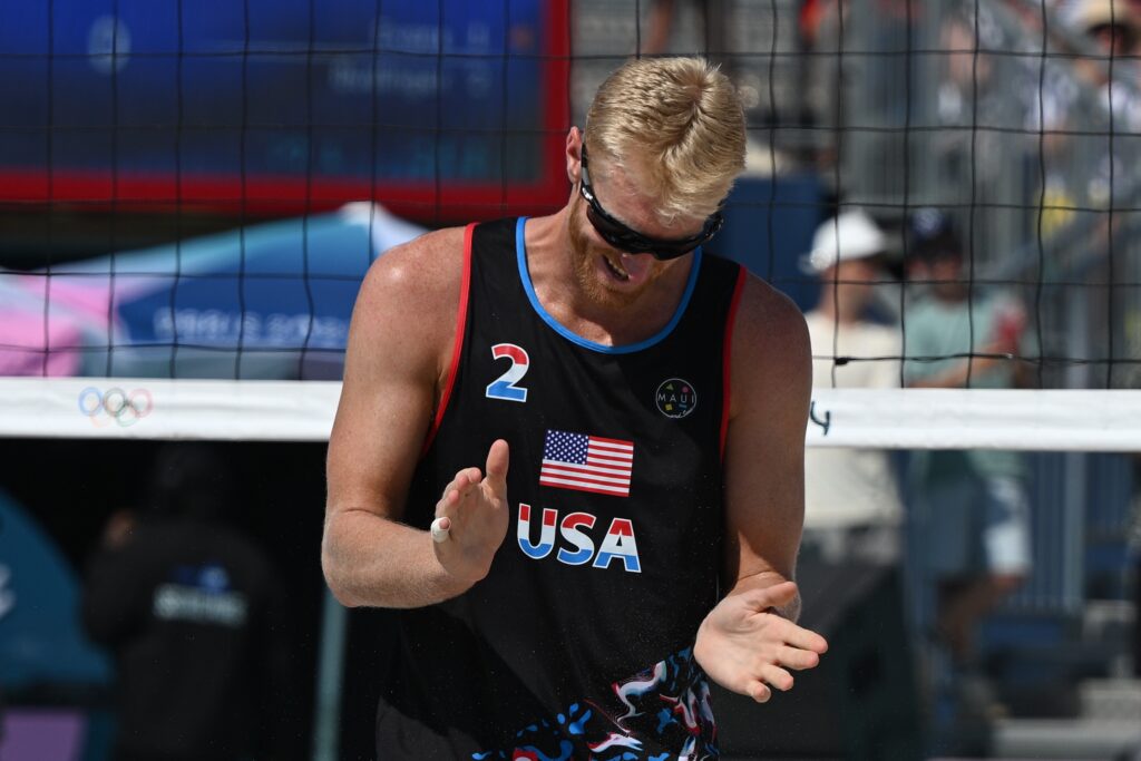 epa11506063 Chase Budinger of USA gestures during their Men Preliminary Phase Pool F match in the Beach Volleyball competitions in the Paris 2024 Olympic Games, at the Eiffel Tower in Paris, France, 29 July 2024.  EPA-EFE/CAROLINE BLUMBERG