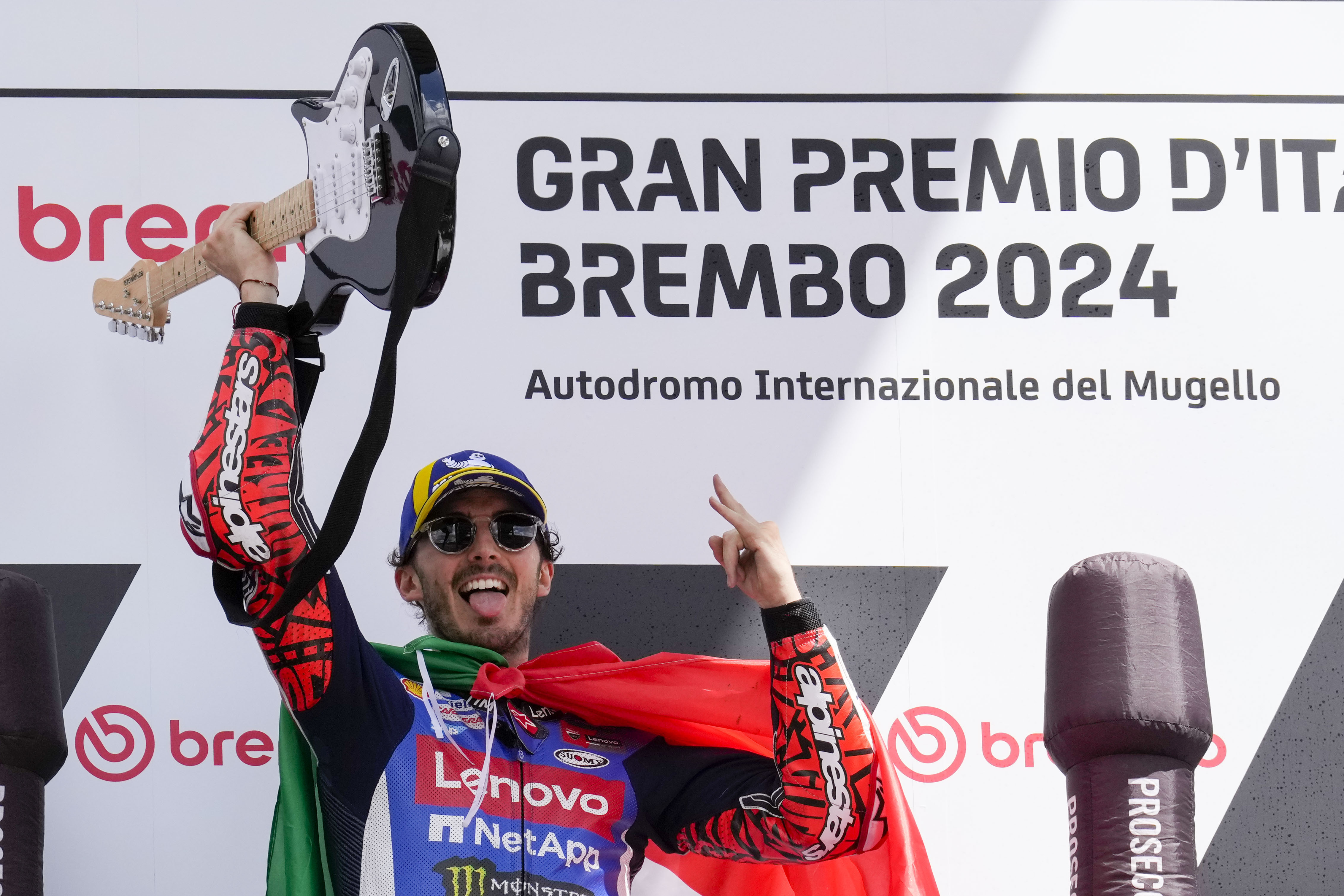 Italian rider Francesco Bagnaia of the Ducati Lenovo Team celebrates on the podium after winning the MotoGP race of the Grand Prix of Italy at the Mugello circuit in Scarperia, Italy, Sunday, June 2, 2024. (AP Photo/Antonio Calanni)