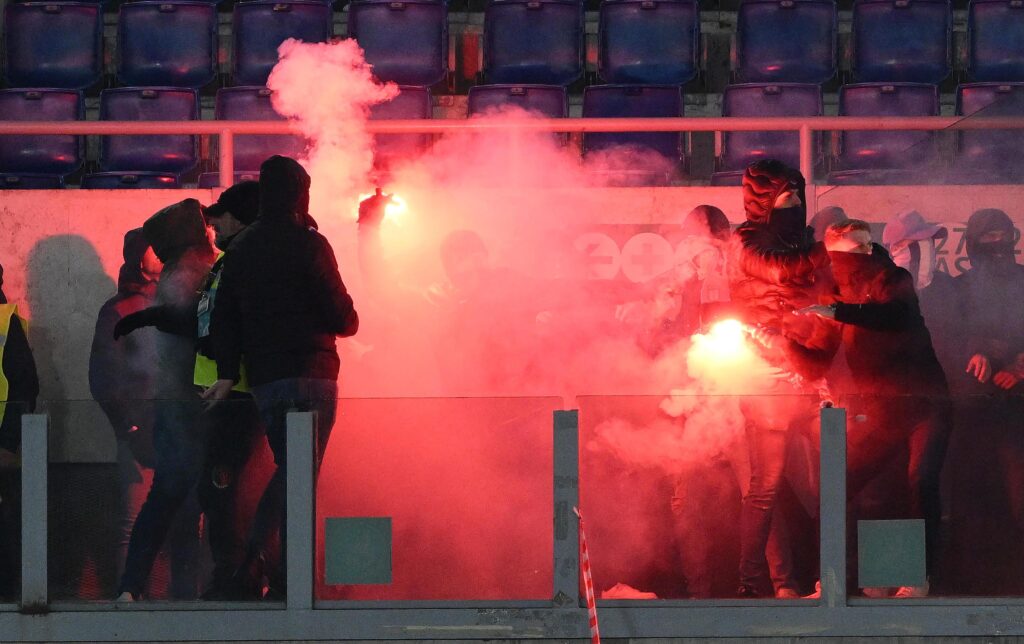 epa11067792 Supporters hold a flare before the Coppa Italia quarter final soccer match between SS Lazio and AS Roma, in Rome, Italy, 10 January 2024.  EPA-EFE/ETTORE FERRARI