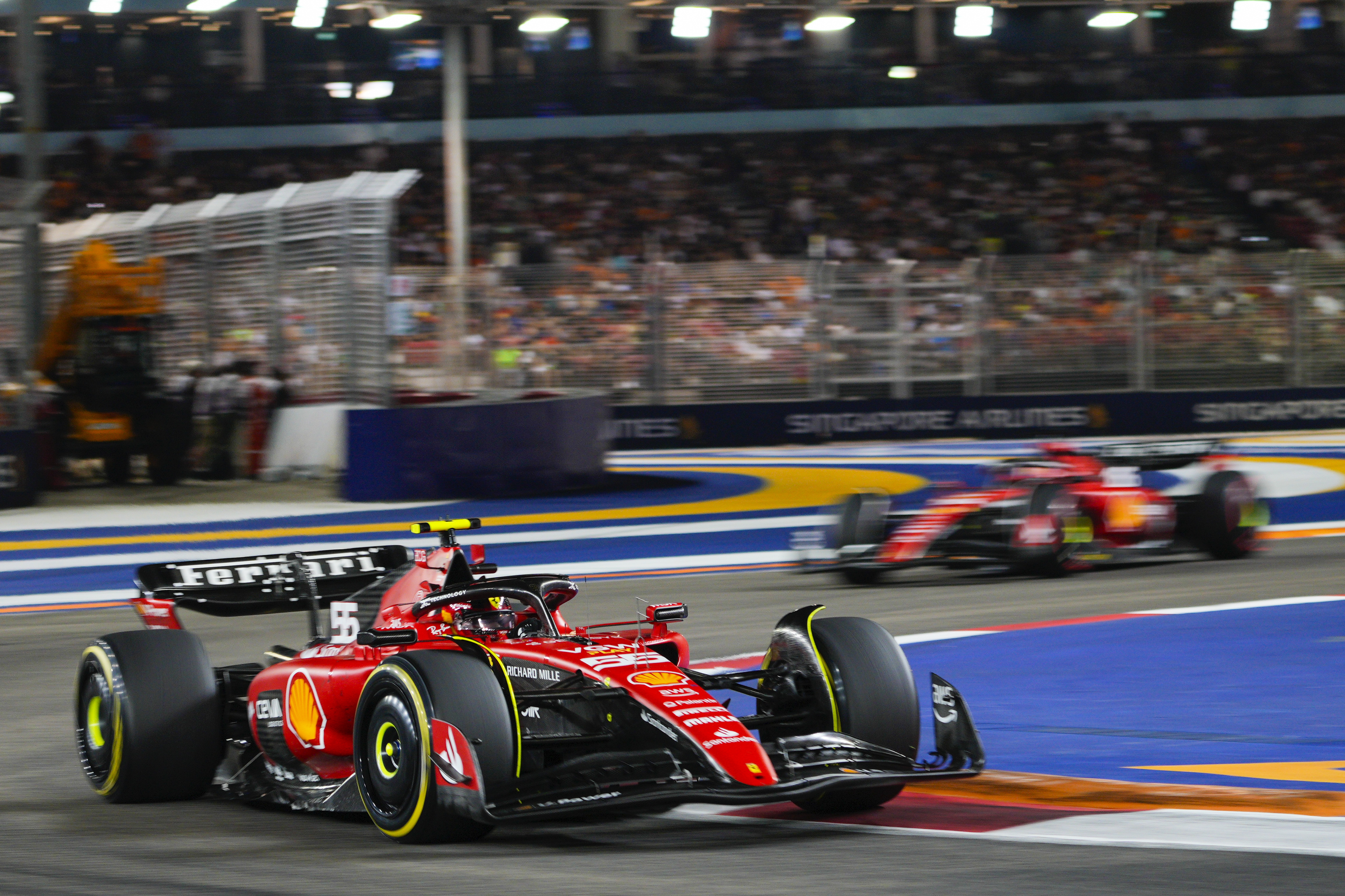 Ferrari driver Carlos Sainz of Spain leads teammate Charles Leclerc of Monaco during the Singapore Formula One Grand Prix at the Marina Bay circuit, Singapore,Sunday, Sept. 17, 2023. (AP Photo/Vincent Thian)