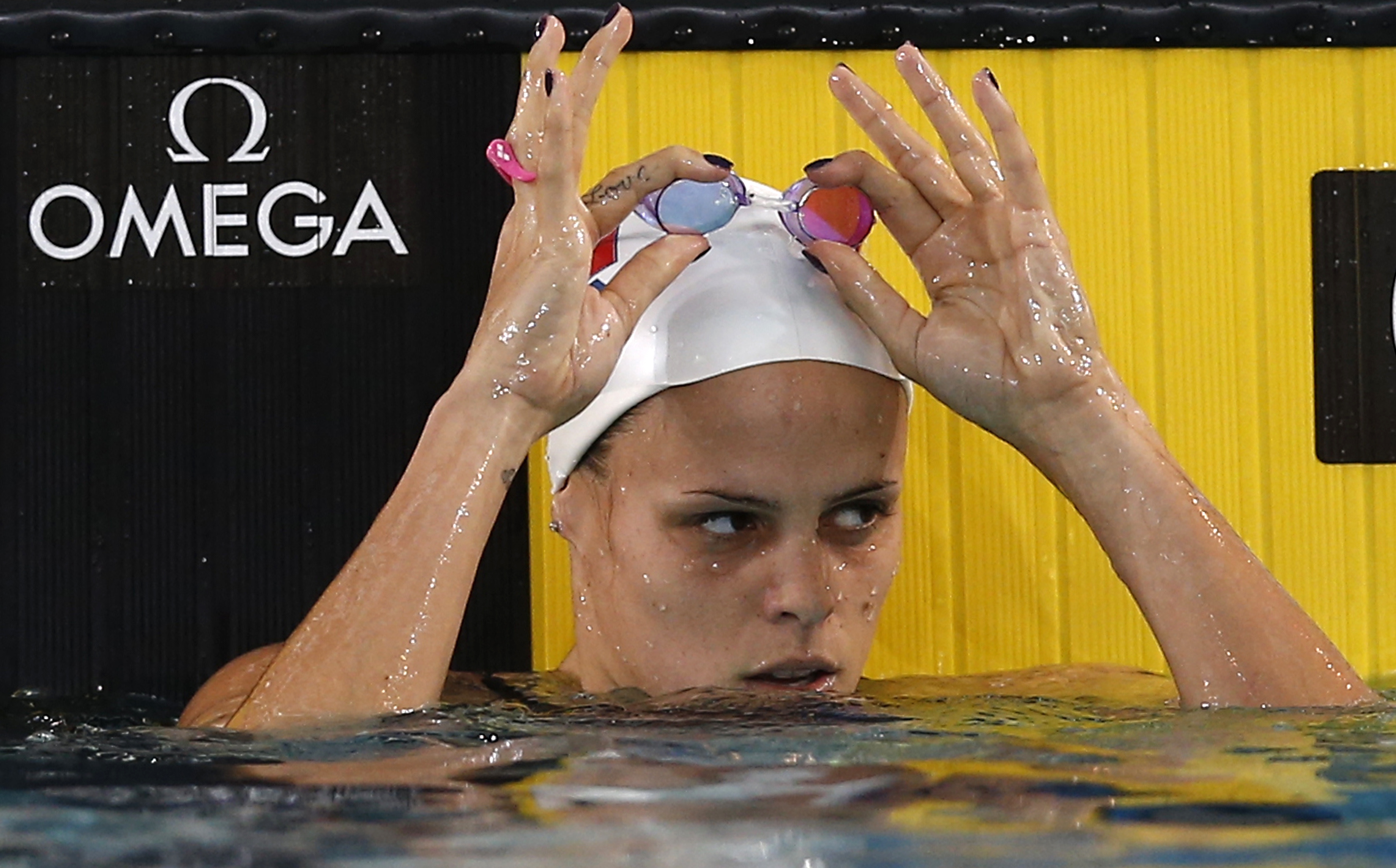 epa03481645 Laure Manaudou of France reacts after competing in the Women's 100m backstroke heats during the European Short Course Swimming Championships in Chartres, France, 22 November 2012.  EPA/IAN LANGSDON