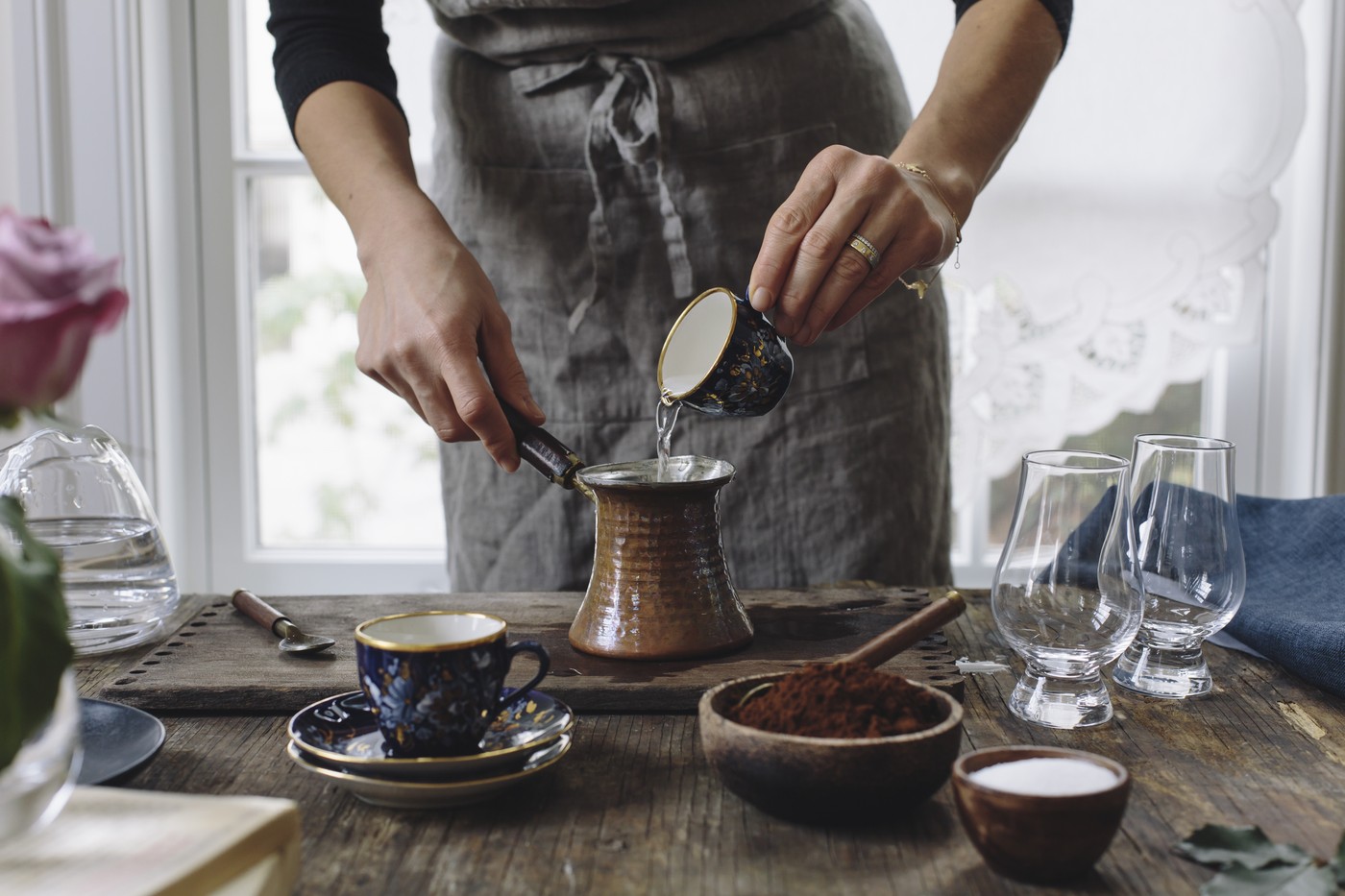 A woman is pouring water into a small pot to make Turkish Coffee.,Image: 724936868, License: Royalty-free, Restrictions: , Model Release: no, Credit line: Aysegul Deniz Sanford / The Picture Pantry / Profimedia