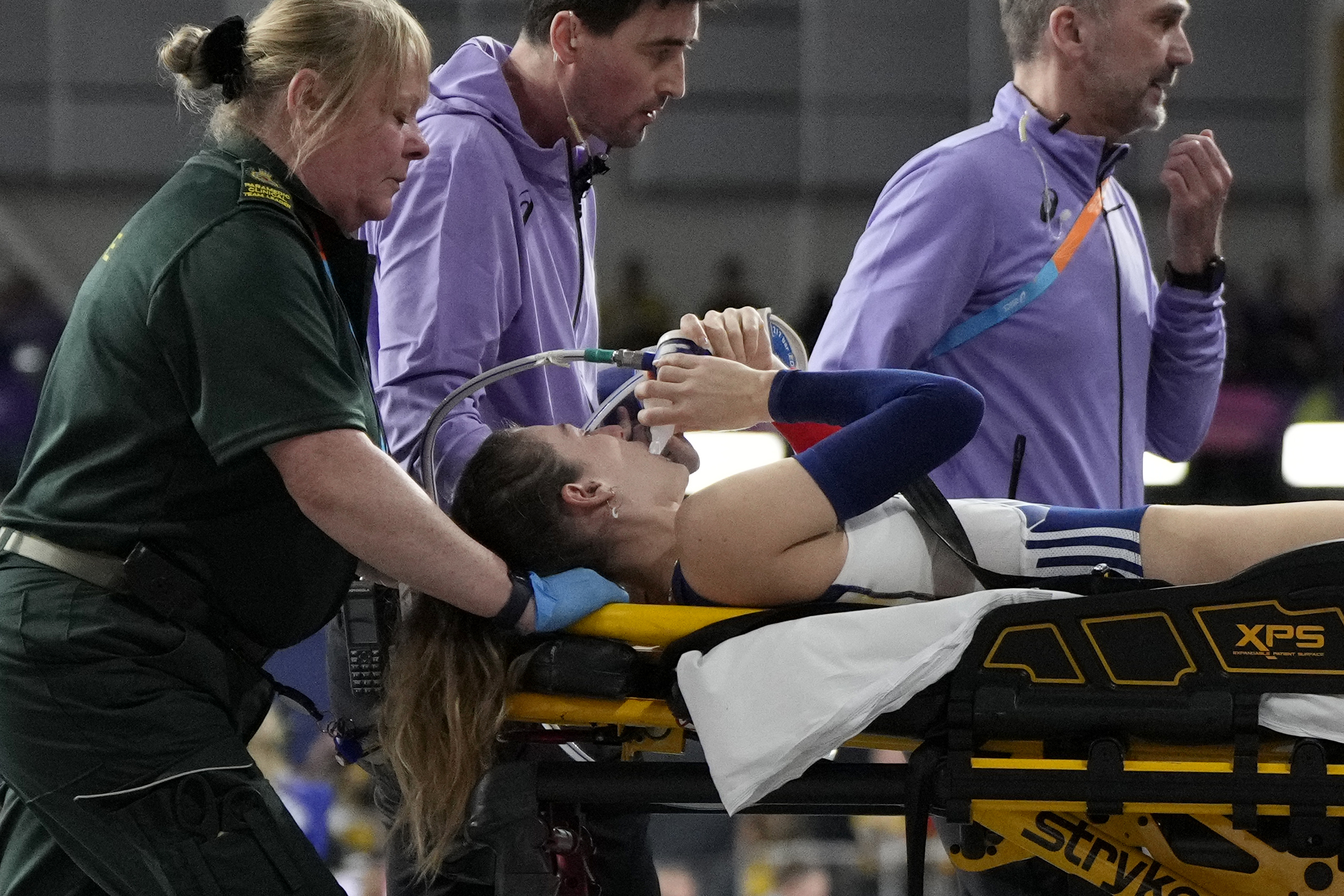 Margot Chevrier, of France, is carried on a stretcher after getting injured in the women's pole vault during the World Athletics Indoor Championships at the Emirates Arena in Glasgow, Scotland, Saturday, March 2, 2024. (AP Photo/Bernat Armangue)
