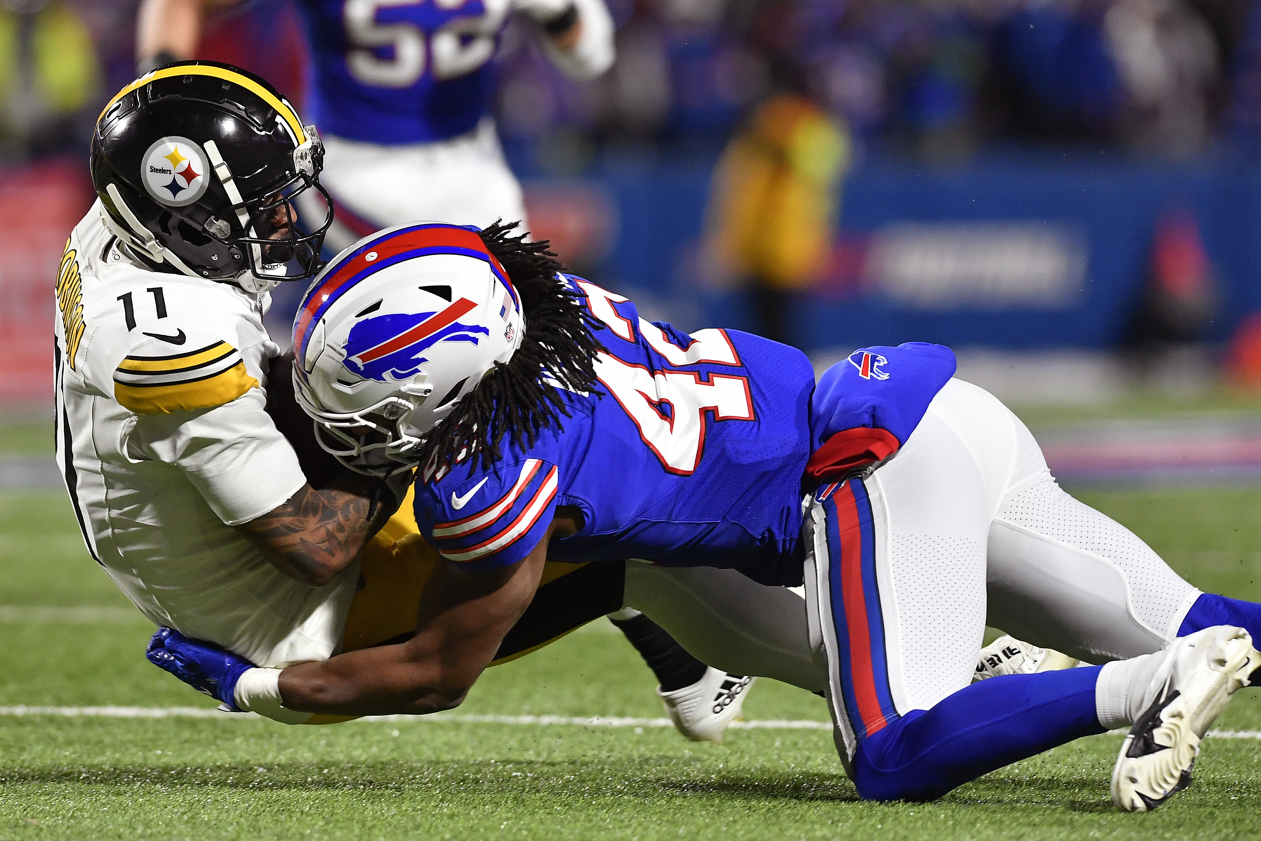 Buffalo Bills linebacker Dorian Williams (42) tackles Pittsburgh Steelers wide receiver Allen Robinson II (11) during the fourth quarter of an NFL wild-card playoff football game, Monday, Jan. 15, 2024, in Buffalo, N.Y. (AP Photo/Adrian Kraus)