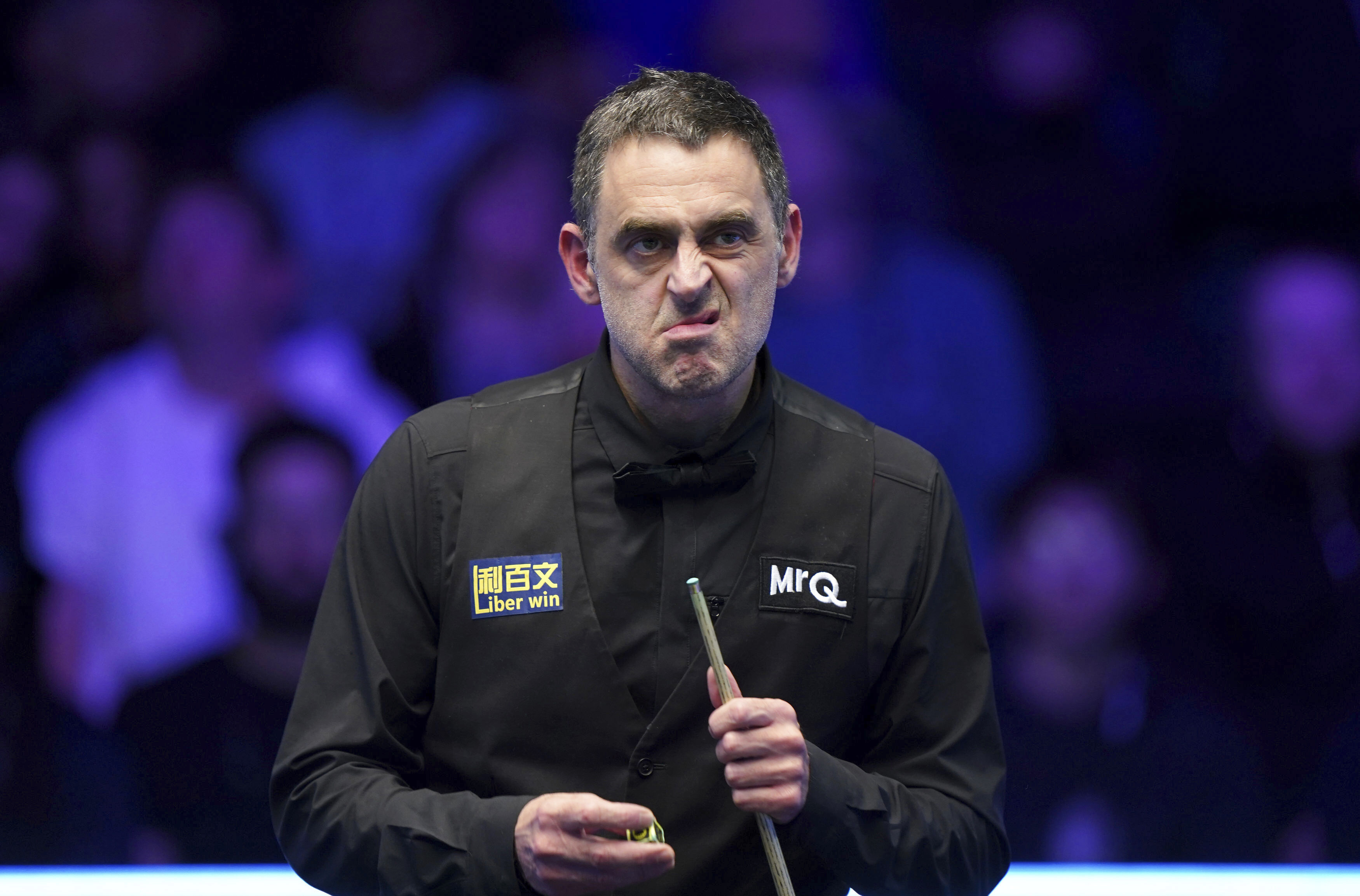England's Ronnie O'Sullivan chalks his cue during the Masters Final against England's Ali Carter during day eight of the Masters at Alexandra Palace, in London, Sunday, Jan. 14, 2024. (Bradley Collyer/PA via AP)