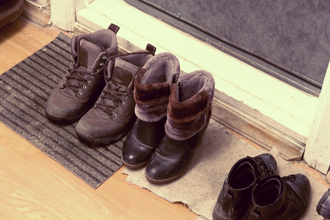 Men's and women's winter shoes are at the front door.