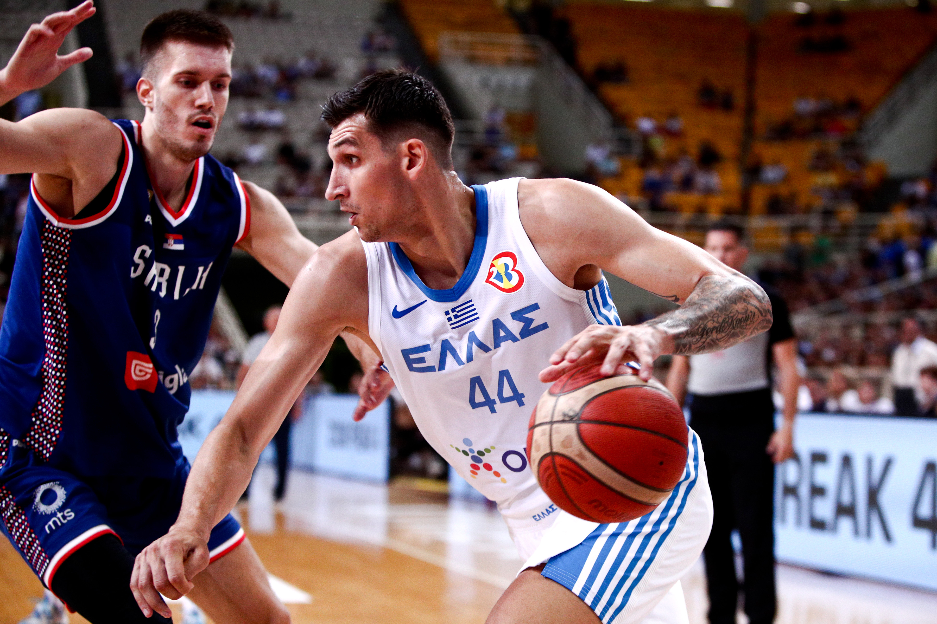 epa10791015 Greece's player Ntinos Mitoglou (R) in action during the Acropolis Tournament Basketball match between national teams of Greece and Serbia at the Olympic Stadium in Athens, Greece, 08 August 2023.  EPA-EFE/GEORGIA PANAGOPOULOU