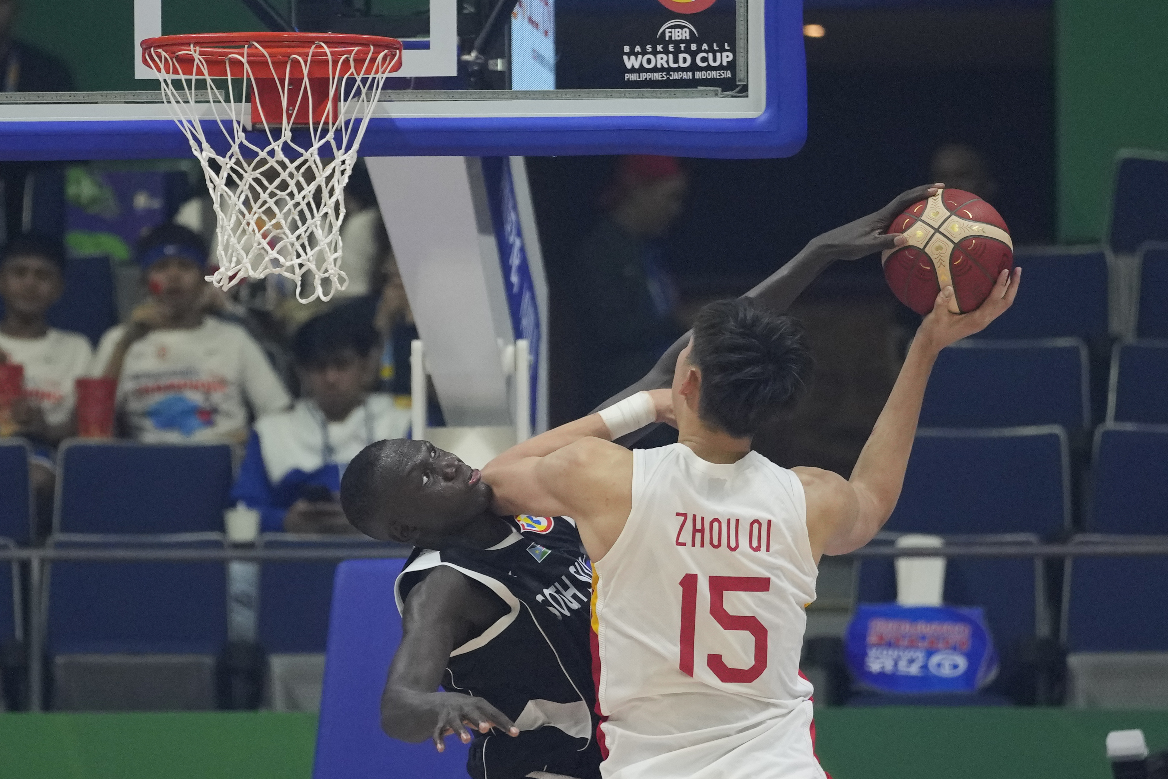 South Sudan center Khaman Madit Maluach (6) tries to reach for the ball against China center Zhou Qi (15) during their Basketball World Cup group B match at the Araneta Coliseum in Manila, Philippines Monday, Aug. 28, 2023. (AP Photo/Aaron Favila)