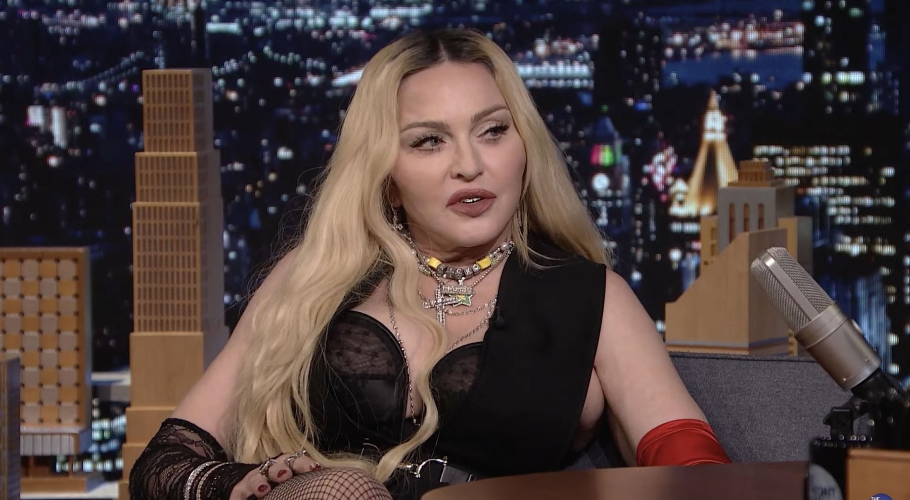 Madonna's interview with The Tonight Show's Jimmy Fallon goes completely off the rails as she climbs on his desk and then flashes the audience