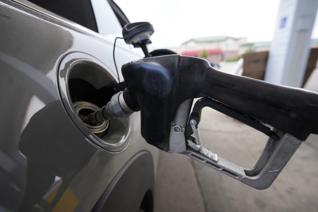 A motorist fills up at a gasoline station, Sunday, July 24, 2022, in Denver. The average price in the United States for regular-grade unleaded gasoline has dropped 32 cents over the past two weeks to $4.54 per gallon. (AP Photo/David Zalubowski)