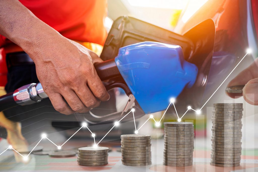 cena nafte, benzina, kombo
Oil price graph, oil pump nozzle and stock market chart. Gas station attendant at work