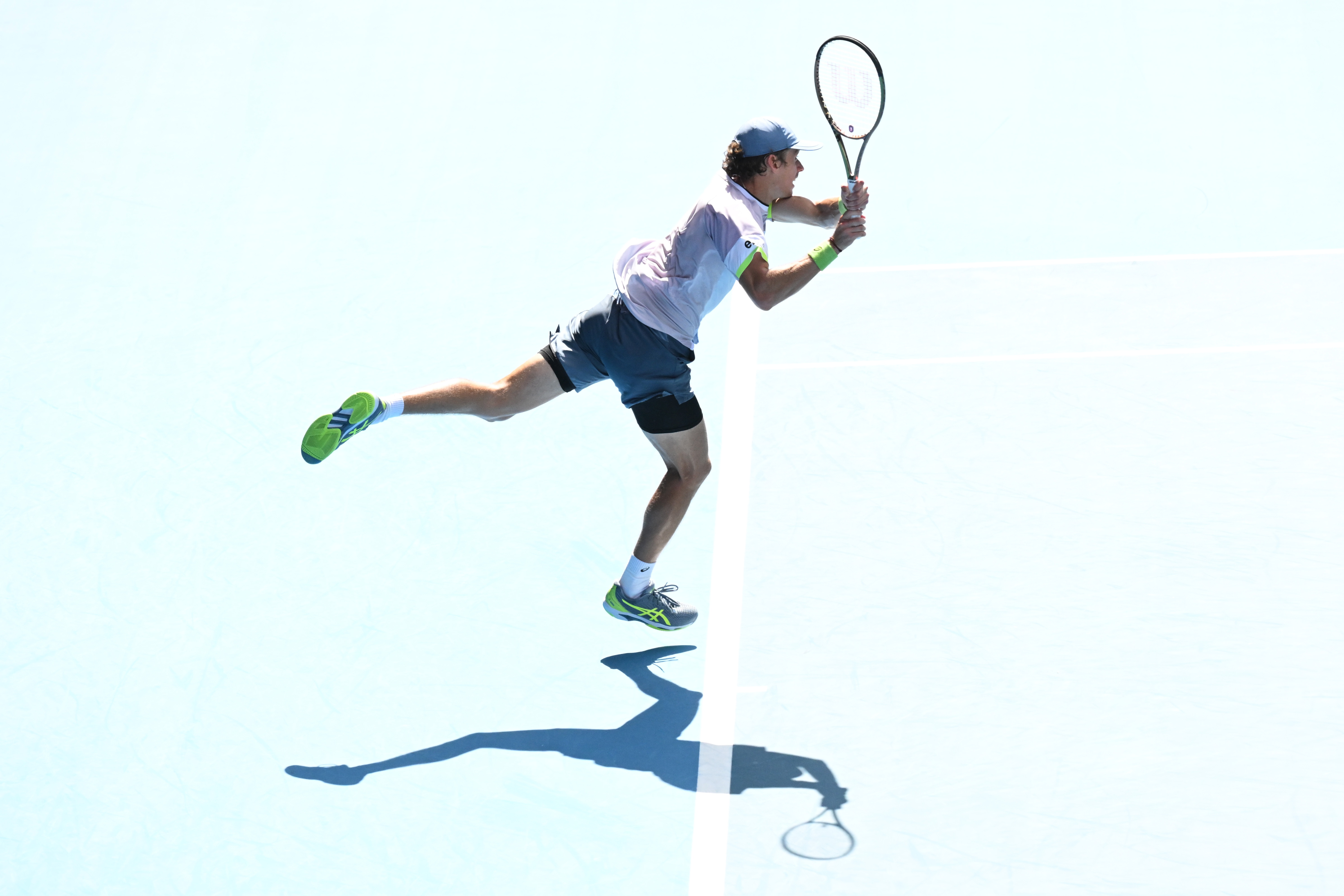 epa10419651 Alex de Minaur of Australia in action during his 2023 Australian Open tennis tournament match against Benjamin Bonzi of France at Melbourne Park in Melbourne, Asutralia 21 January 2023.  EPA-EFE/LUKAS COCH AUSTRALIA AND NEW ZEALAND OUT