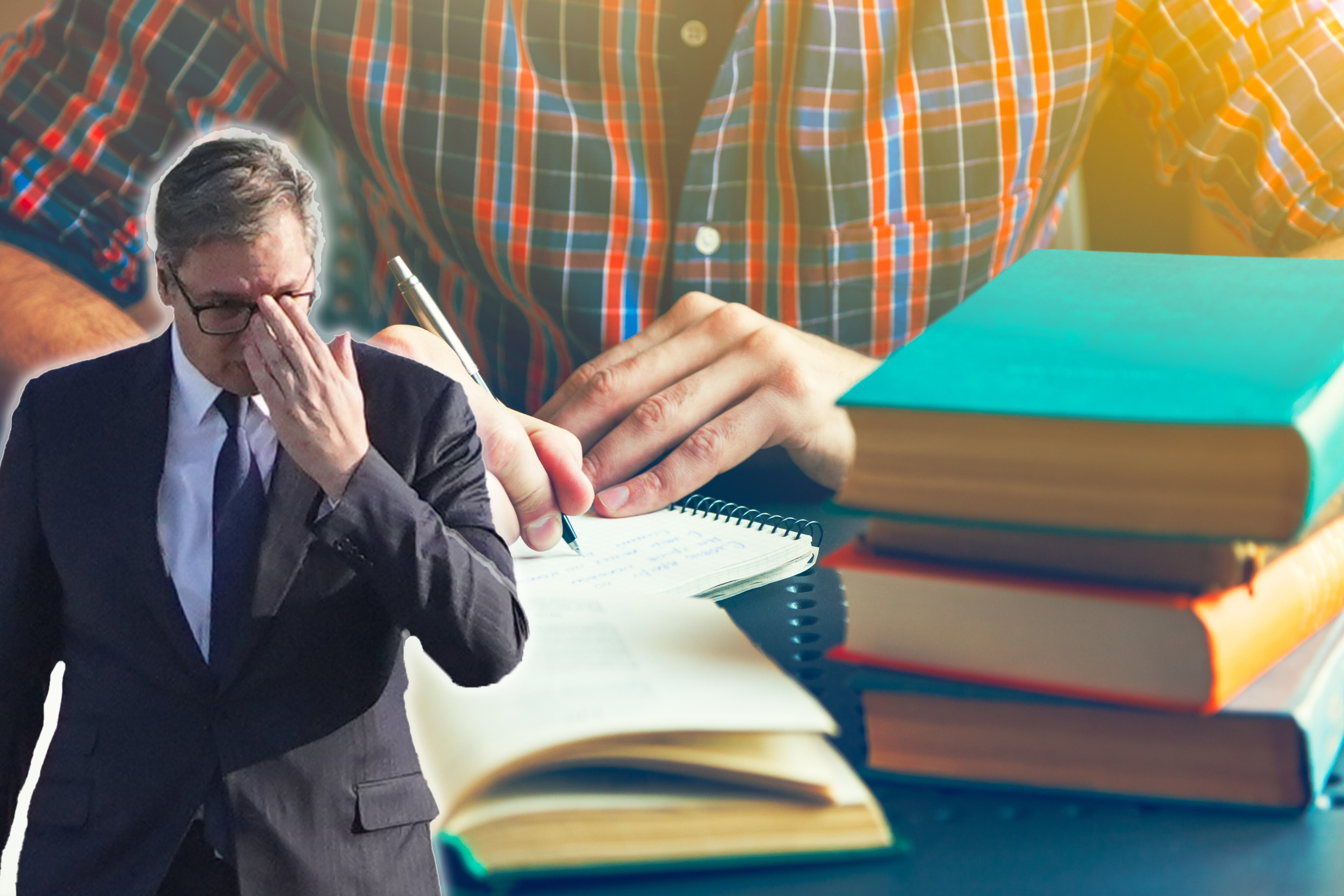 male hand writing with pen near books