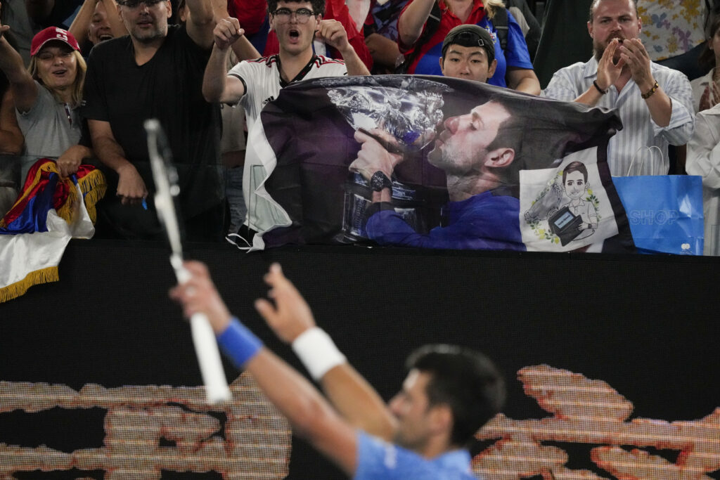 Supporters of Novak Djokovic of Serbia react after he defeated Roberto Carballes Baena of Spain in their first round match at the Australian Open tennis championship in Melbourne, Australia, Wednesday, Jan. 18, 2023. (AP Photo/Aaron Favila)