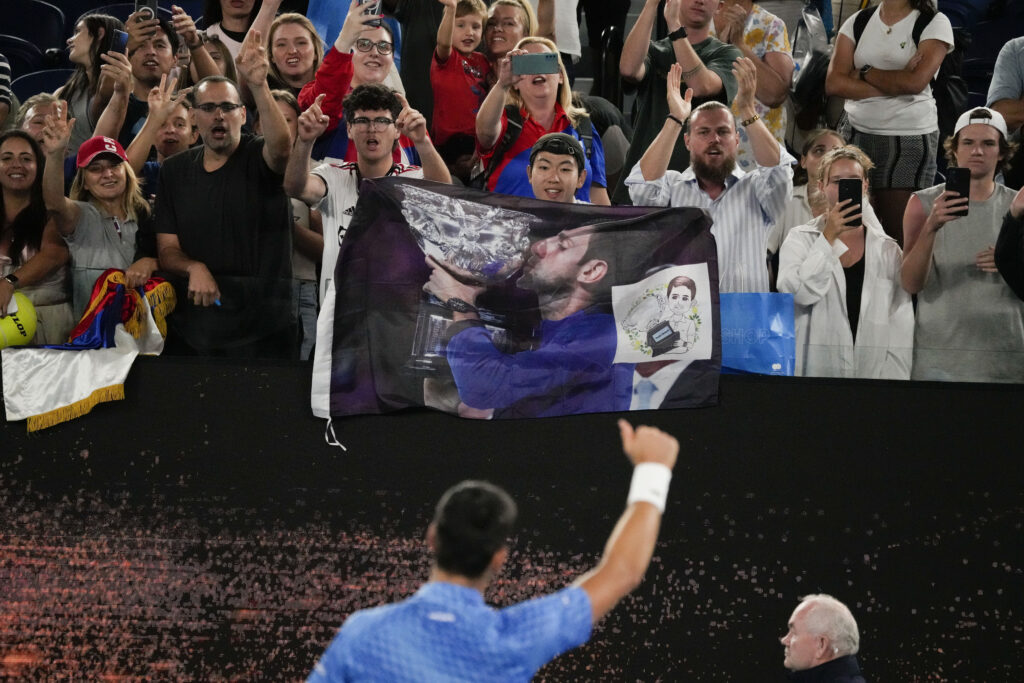 Novak Djokovic of Serbia gestures to his supporters after defeating Roberto Carballes Baena of Spain in their first round match at the Australian Open tennis championship in Melbourne, Australia, Wednesday, Jan. 18, 2023. (AP Photo/Aaron Favila)