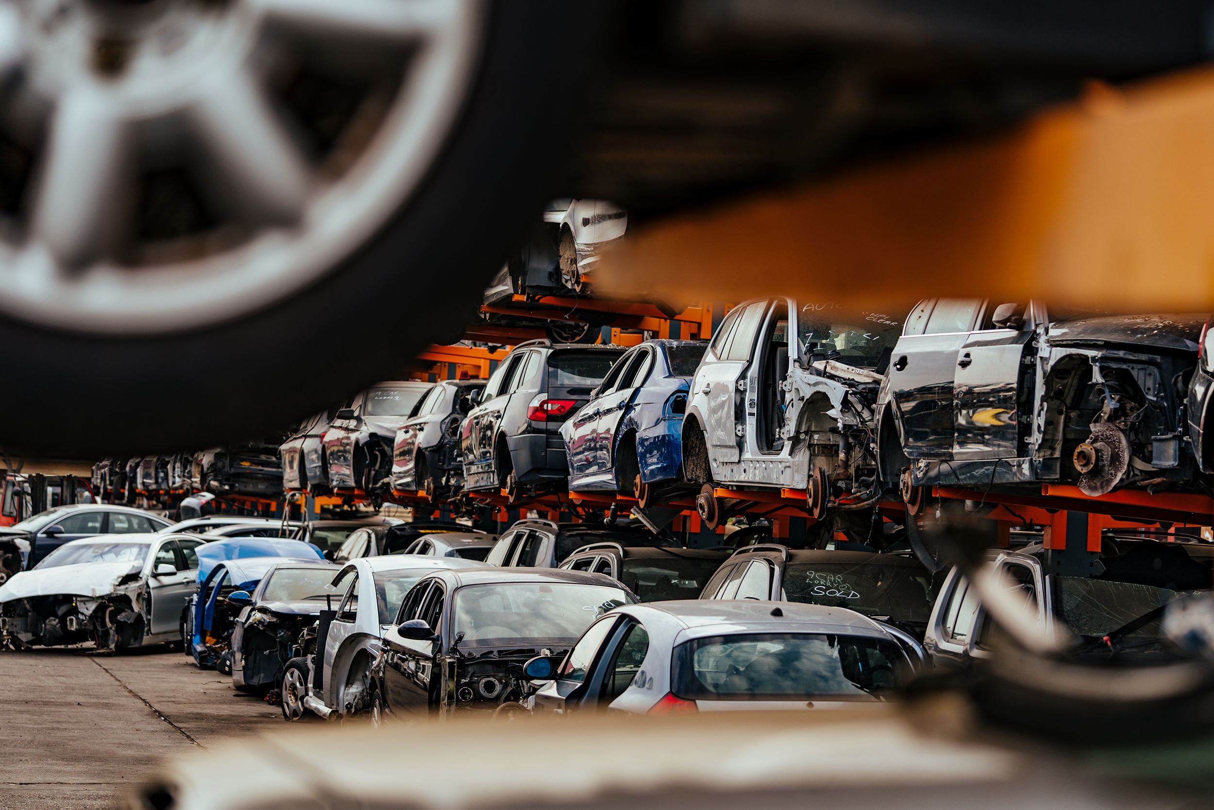 Damaged cars waiting in a scrapyard to be recycled or used for spare part Tagovi: automobili, reciklaža