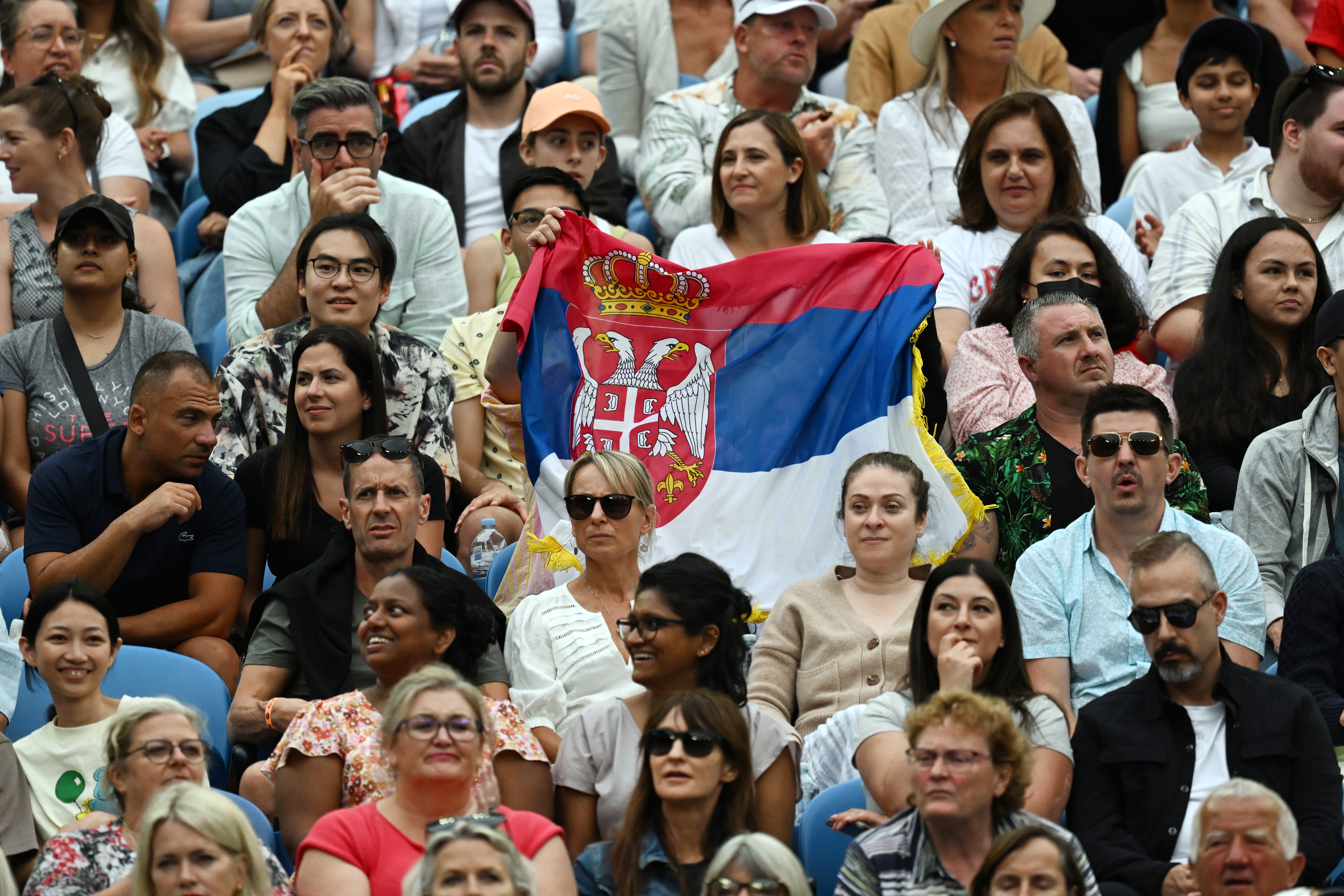 epa10419959 Fans wave the Serbian flag during the Grigor Dimitrov of Bulgaria and Novak Djokovic of Serbia match at the 2023 Australian Open tennis tournament in Melbourne, Australia, 21 January 2023.  EPA-EFE/LUKAS COCH  AUSTRALIA AND NEW ZEALAND OUT