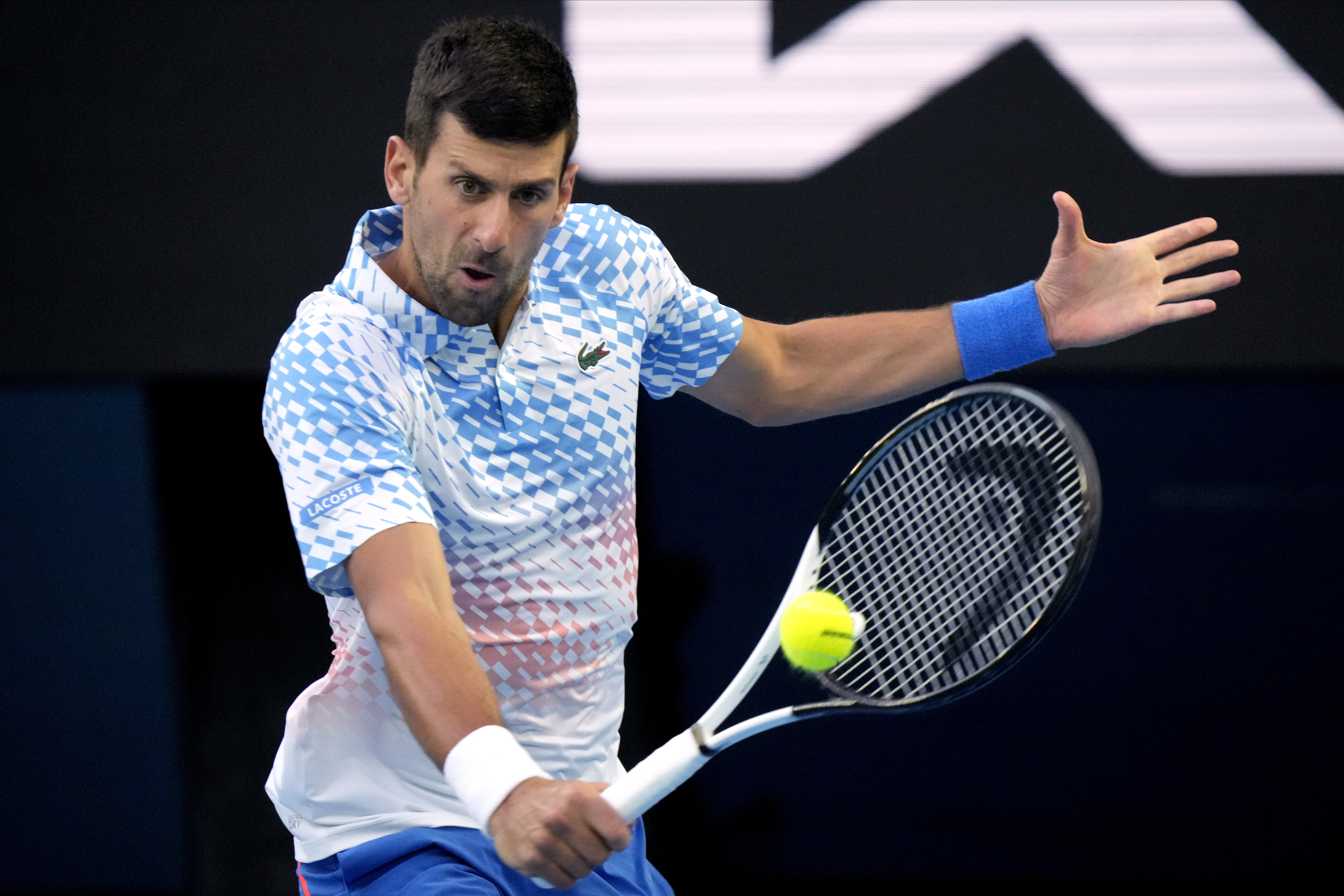 Novak Djokovic of Serbia plays a backhand return to Andrey Rublev of Russia during their quarterfinal match at the Australian Open tennis championship in Melbourne, Australia, Wednesday, Jan. 25, 2023. (AP Photo/Dita Alangkara)