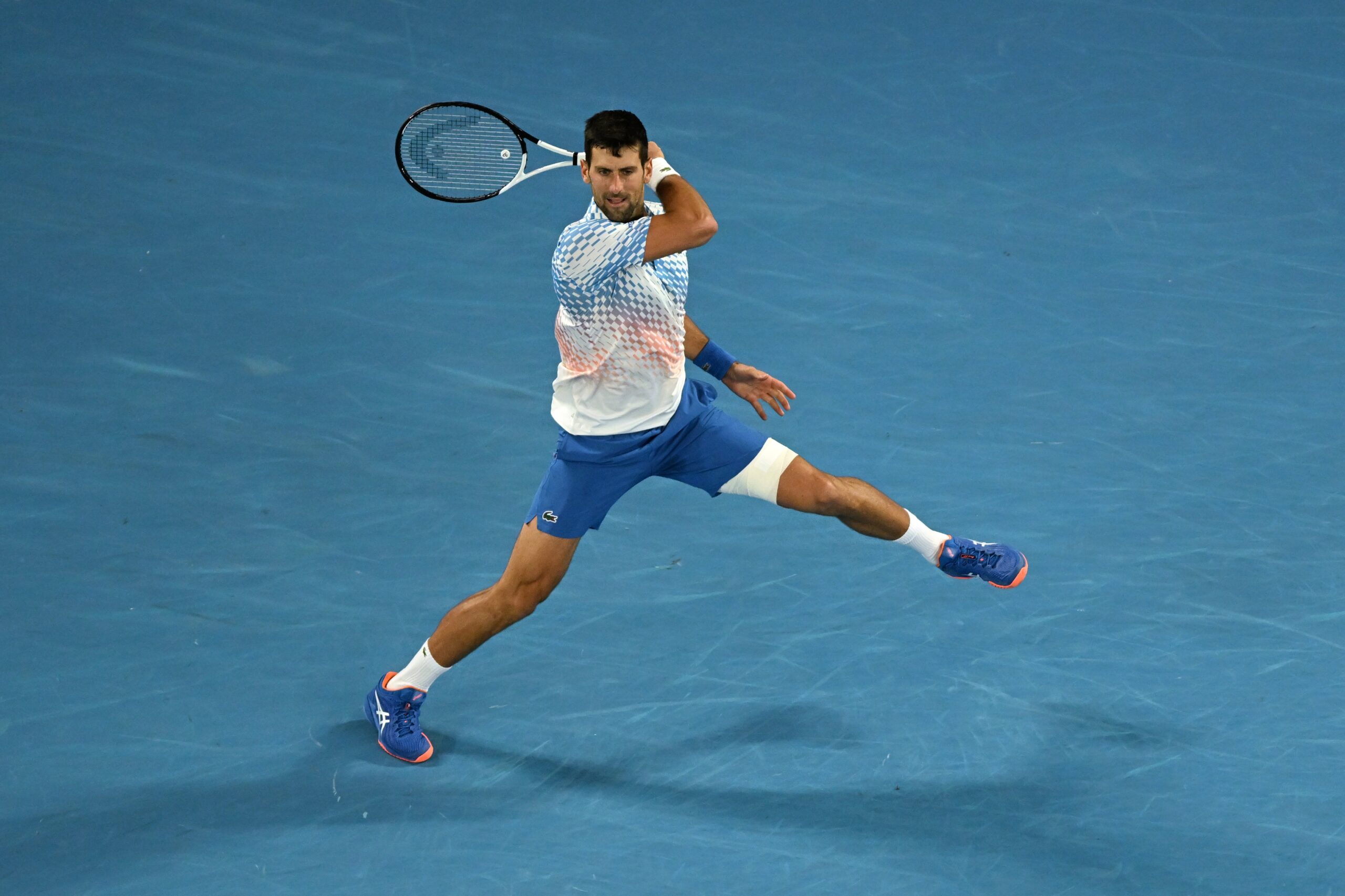 epa10428217 Novak Djokovic of Serbia in action during his quarterfinal match against Andrey Rublev of Russia at the 2023 Australian Open tennis tournament in Melbourne, Australia, 25 January 2023.  EPA-EFE/LUKAS COCH AUSTRALIA AND NEW ZEALAND OUT
