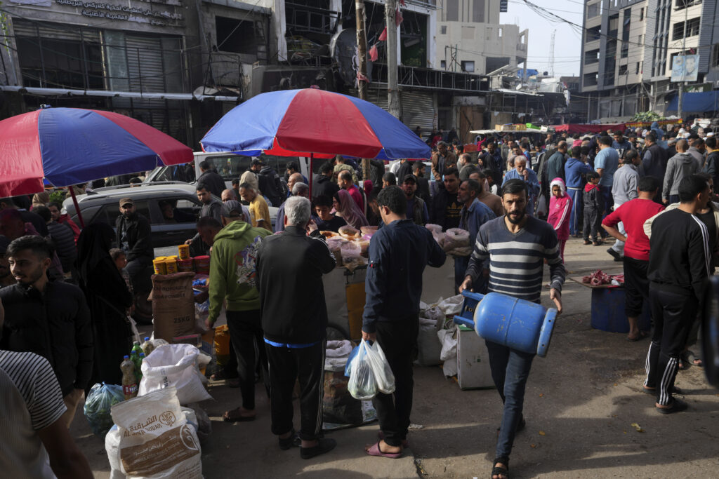 Palestinians visit an open-air market in Nusseirat refugee camp, central Gaza Strip, on Saturday, Nov. 25, 2023. on the second day of the temporary ceasefire between Hamas and Israel. (AP Photo/Adel Hana)