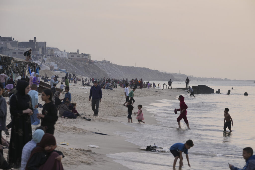 Palestinians visit the beach in Deir al Balah, Gaza Strip, on the second day of a cease-fire between Israel and Hamas, Saturday, Nov. 25, 2023. (AP Photo/Hatem Moussa)